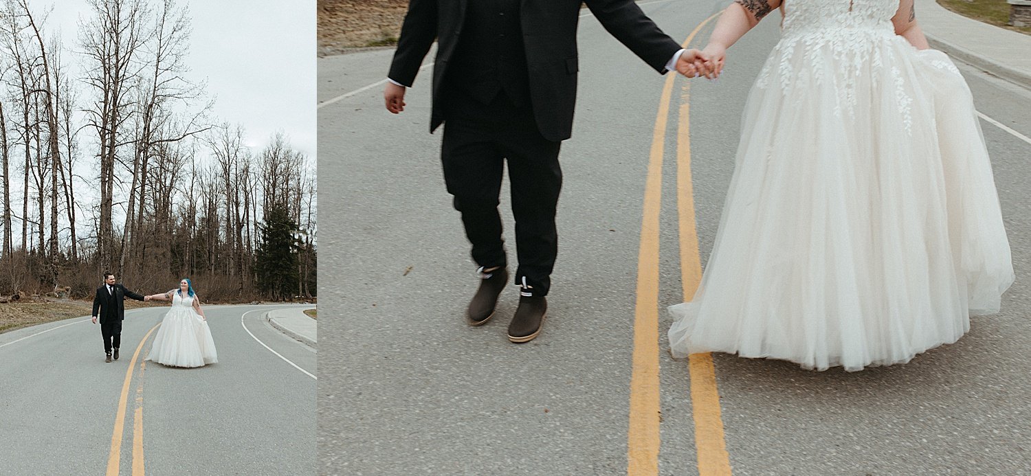  Bride and groom walking down the road with mountains in the background by Rachel Struve Photography 