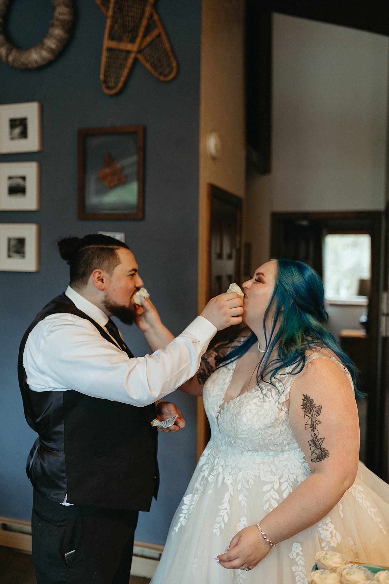  Newlyweds feeding each other cupcakes at Airbnb by Rachel Struve Photography 