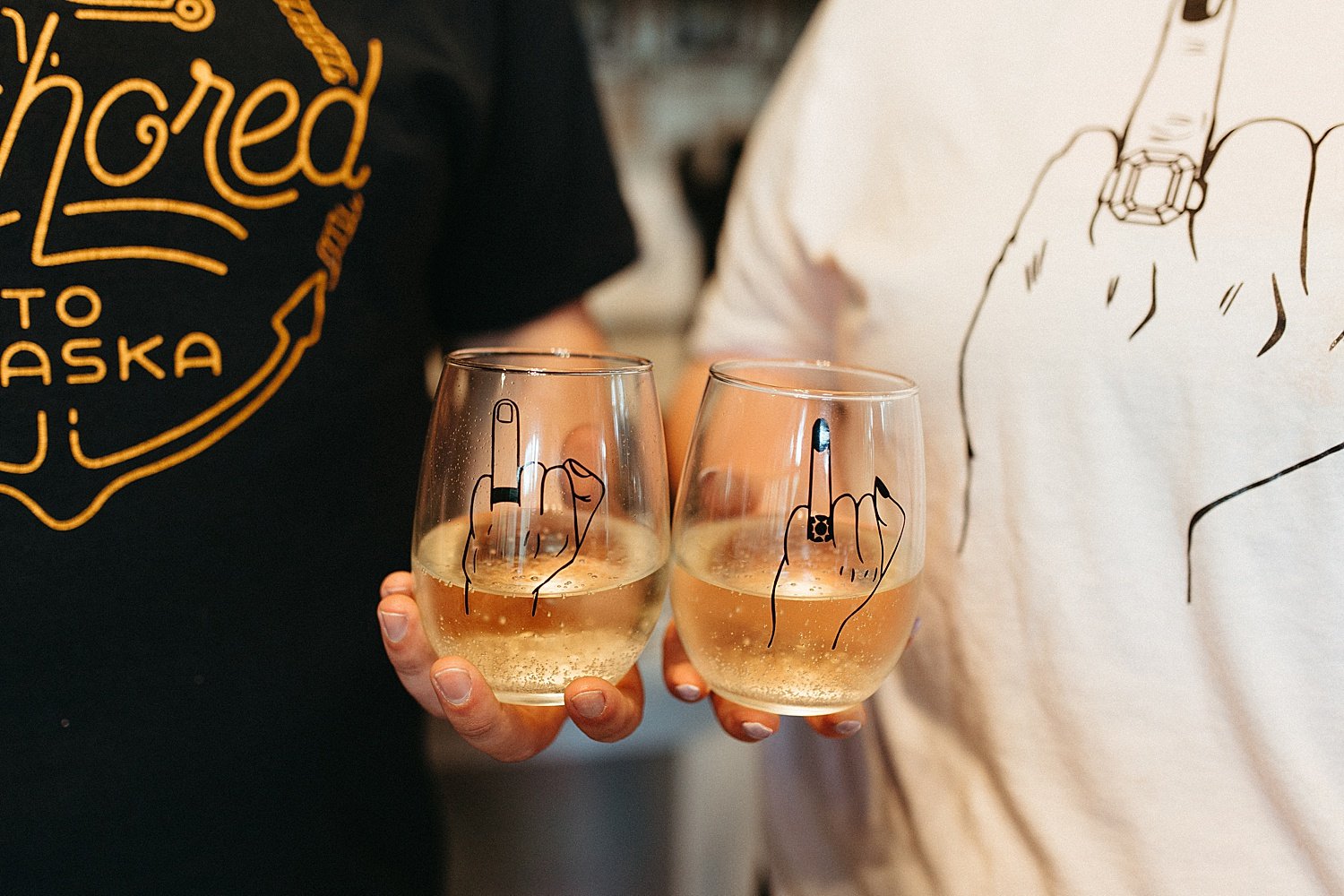  Custom wine glasses held by bride and groom at private reception by Alaska Elopement Photographer 