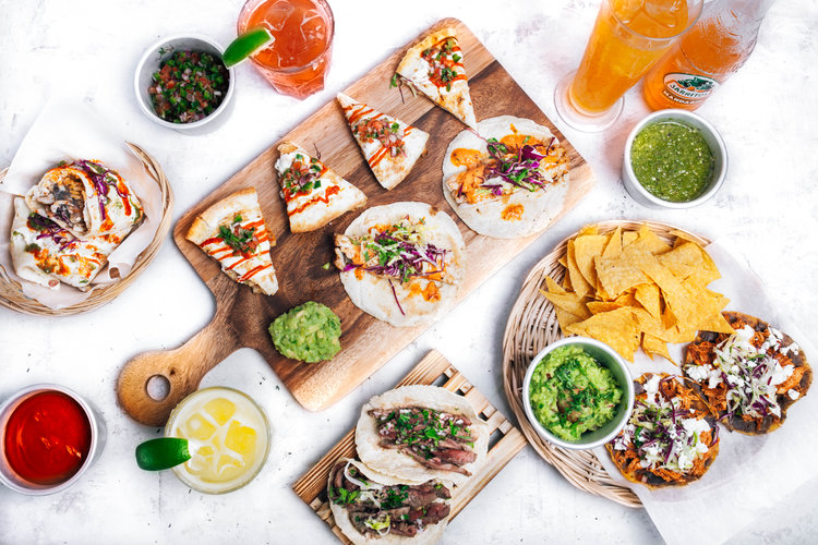 Flat lay of tacos and beverages from Papi Taco's