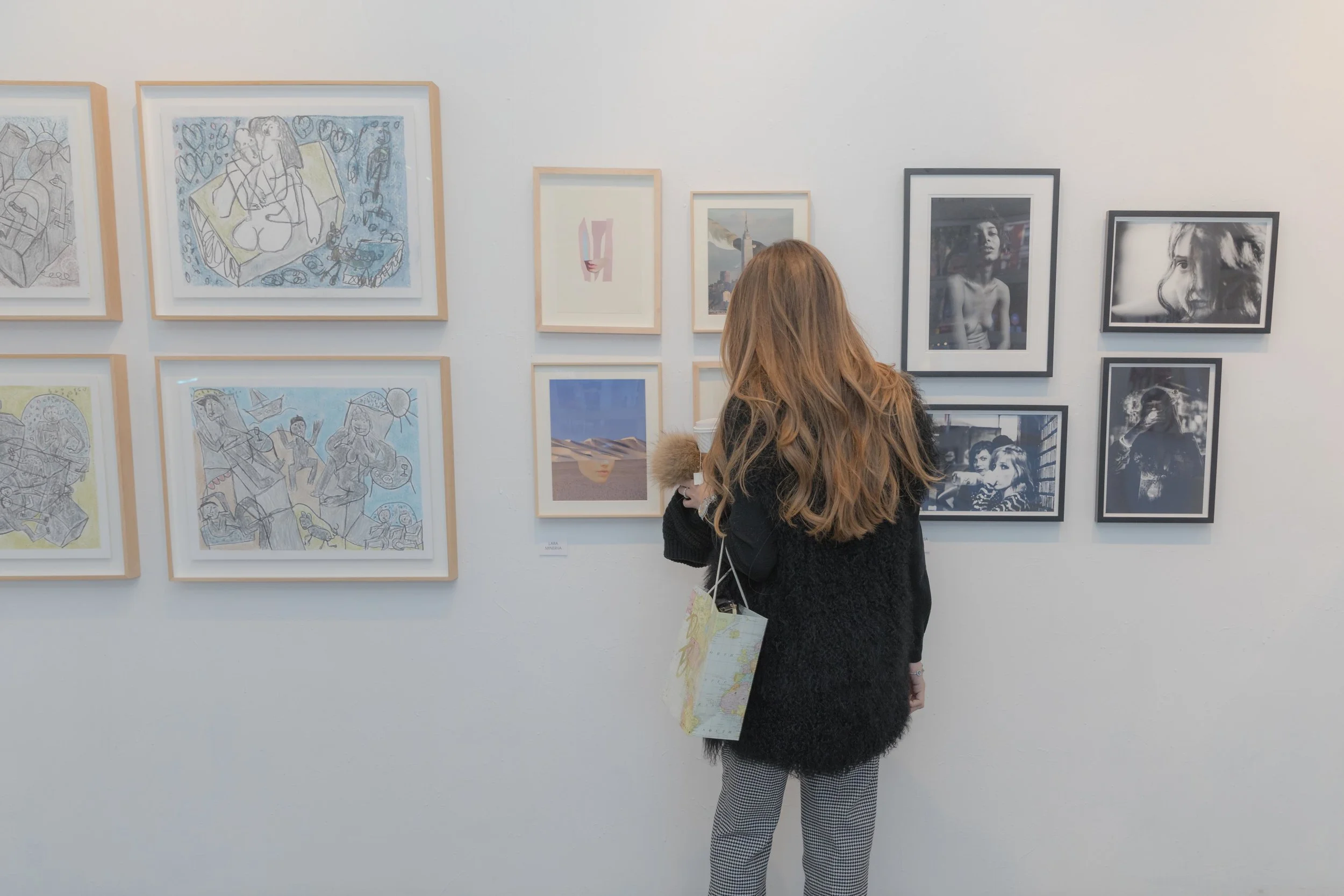 Art influencer and NYC tour guide Patricia de Picciotto admiring artwork by Ygal Gbay, Lara Minerva, and Evelyn Sosa Rojas (left to right)