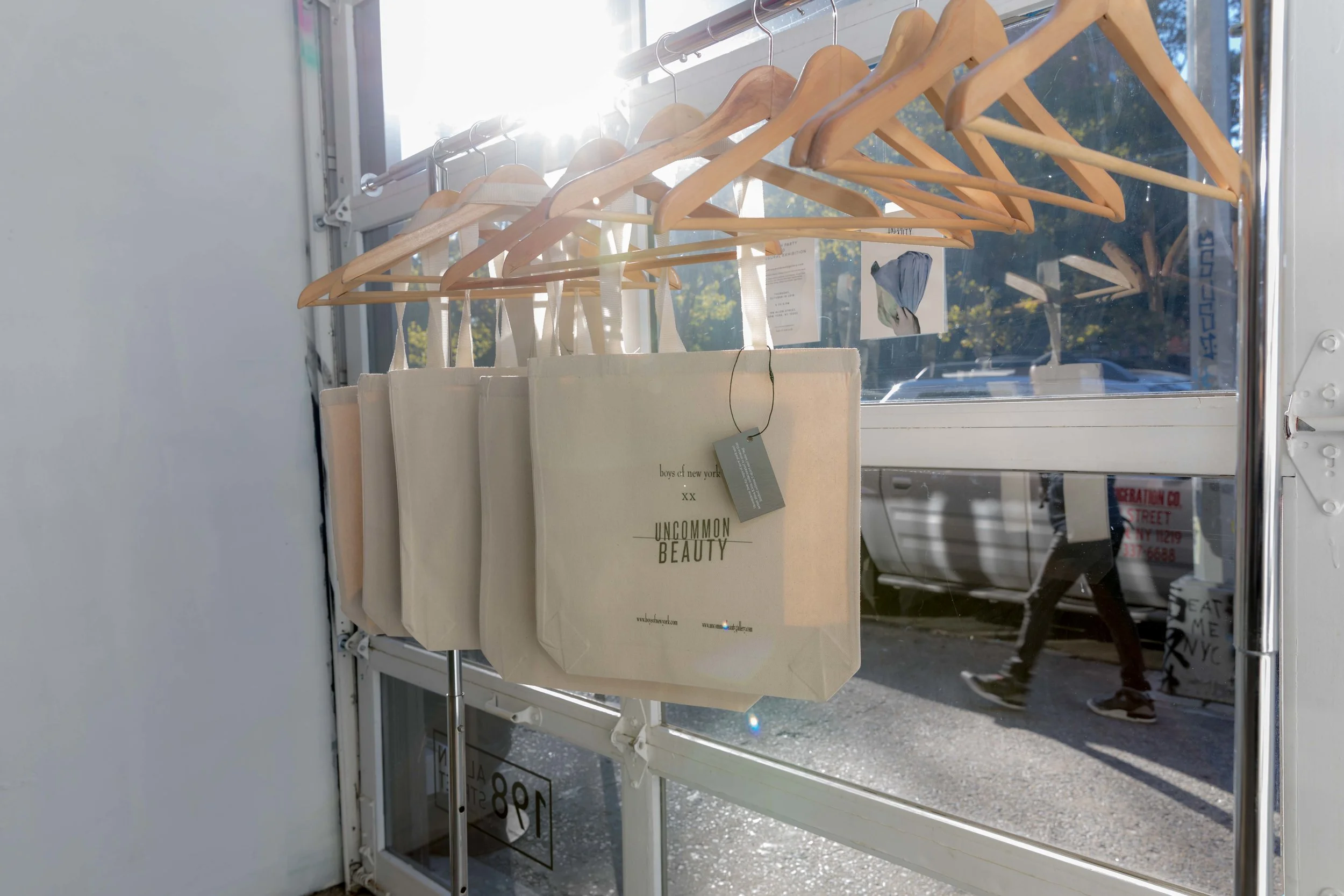 Uncommon Beauty Gallery partnered with fashion brand boys of new york to created limited edition tote bags and wearable art in celebration of the launch.