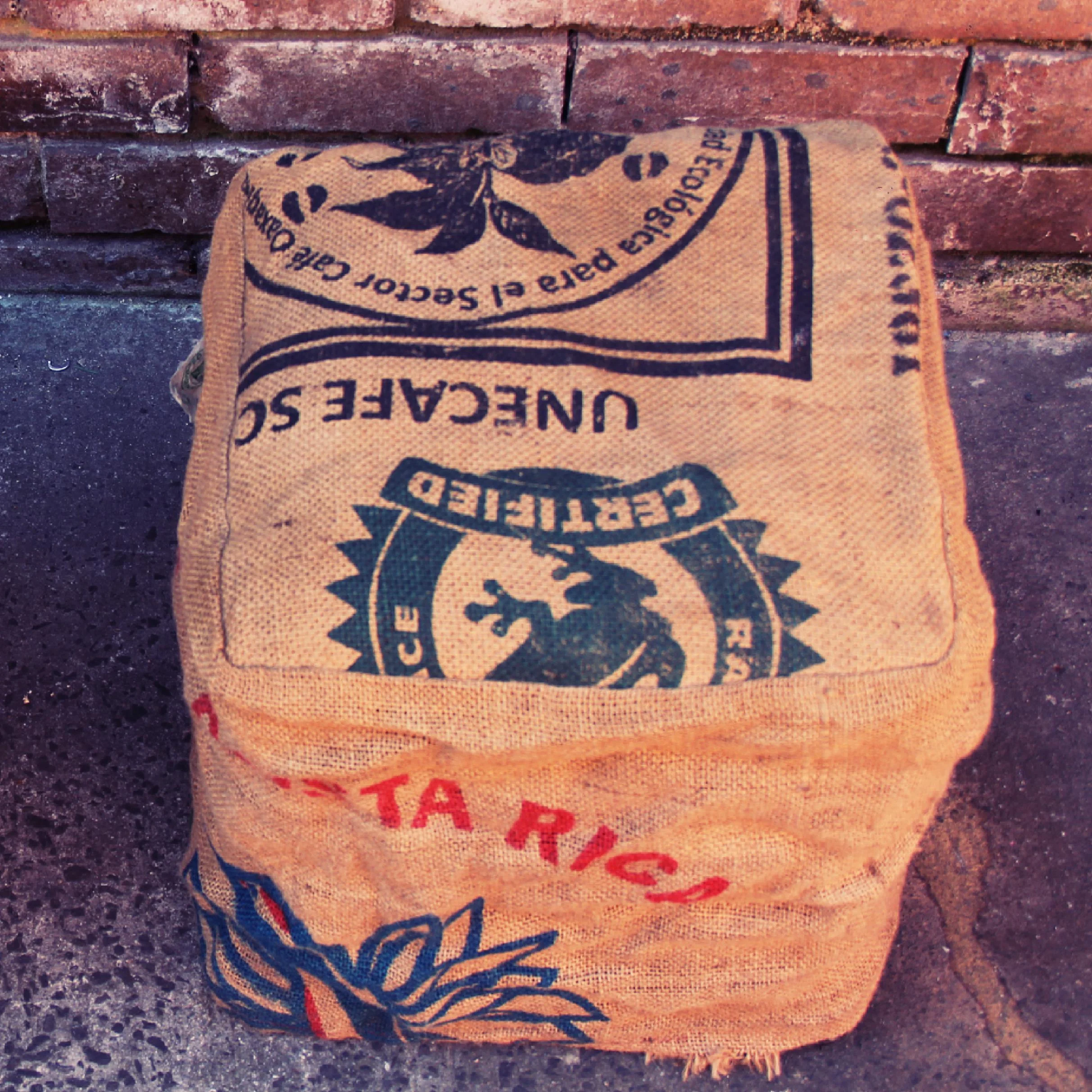 Milk crate seat with coffee sack cover