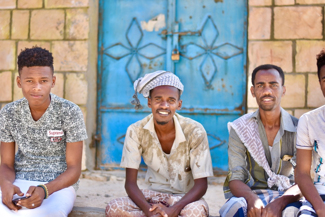 Yemeni men sitting on a porch, smiling