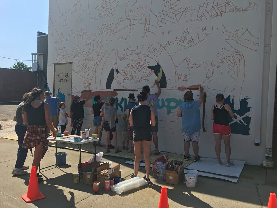  Members of the Vermillion community gather to pick up paint brushes and color in the lines. This community paint day was held in July 2019. 