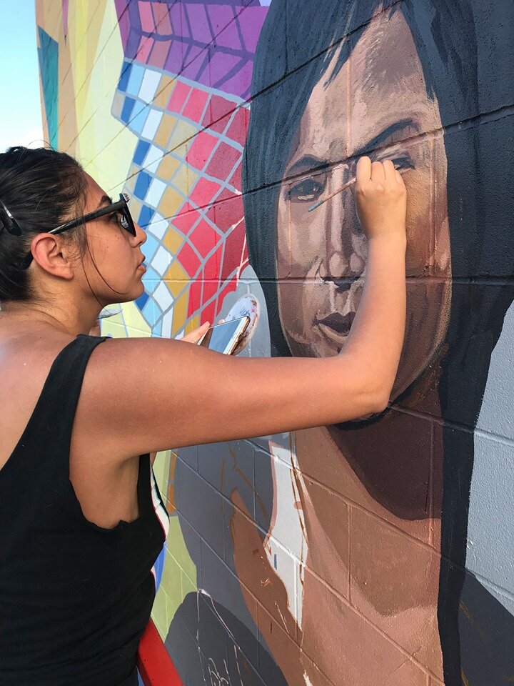  Reyna Hernandez brings the mural’s central figure to life.  