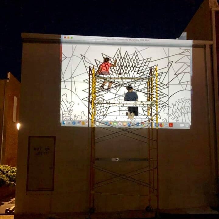  Line art is projected onto the primed wall of the Coyote Twin at night for the artists to trace. 