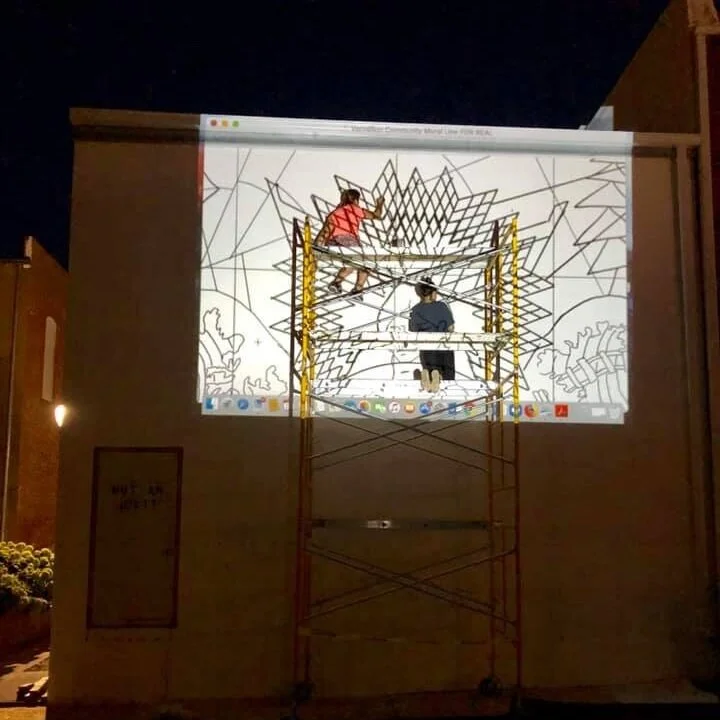 Line art is projected onto the primed wall of the Coyote Twin at night for the artists to trace.