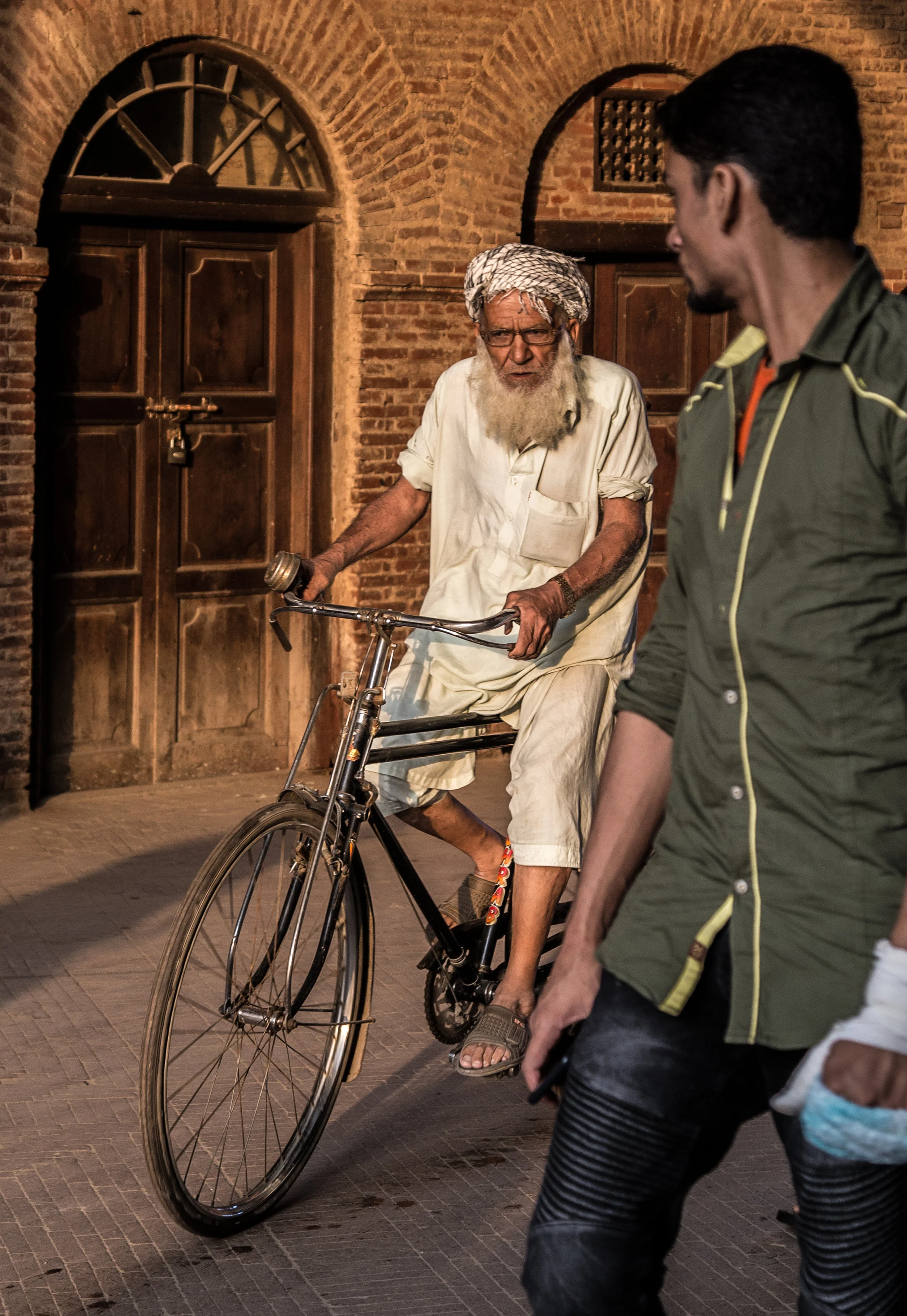 man riding a bike, photos of pakistan, street photography in pakistan, photography for sale, street photography for sale, travel photography