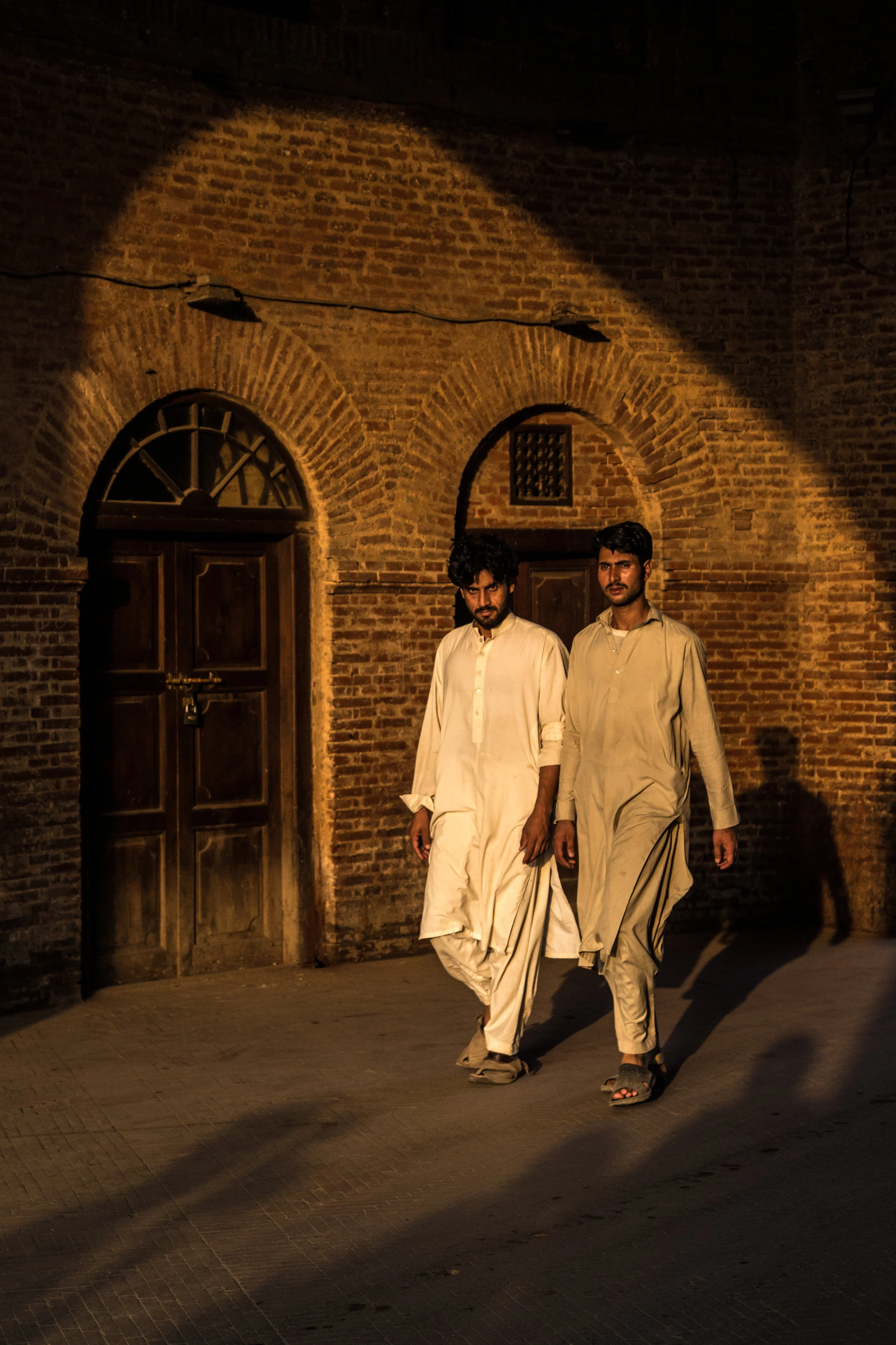 two men in ethnic clothes walking, photos of pakistan, street photography in pakistan, photography for sale, street photography for sale, travel photography