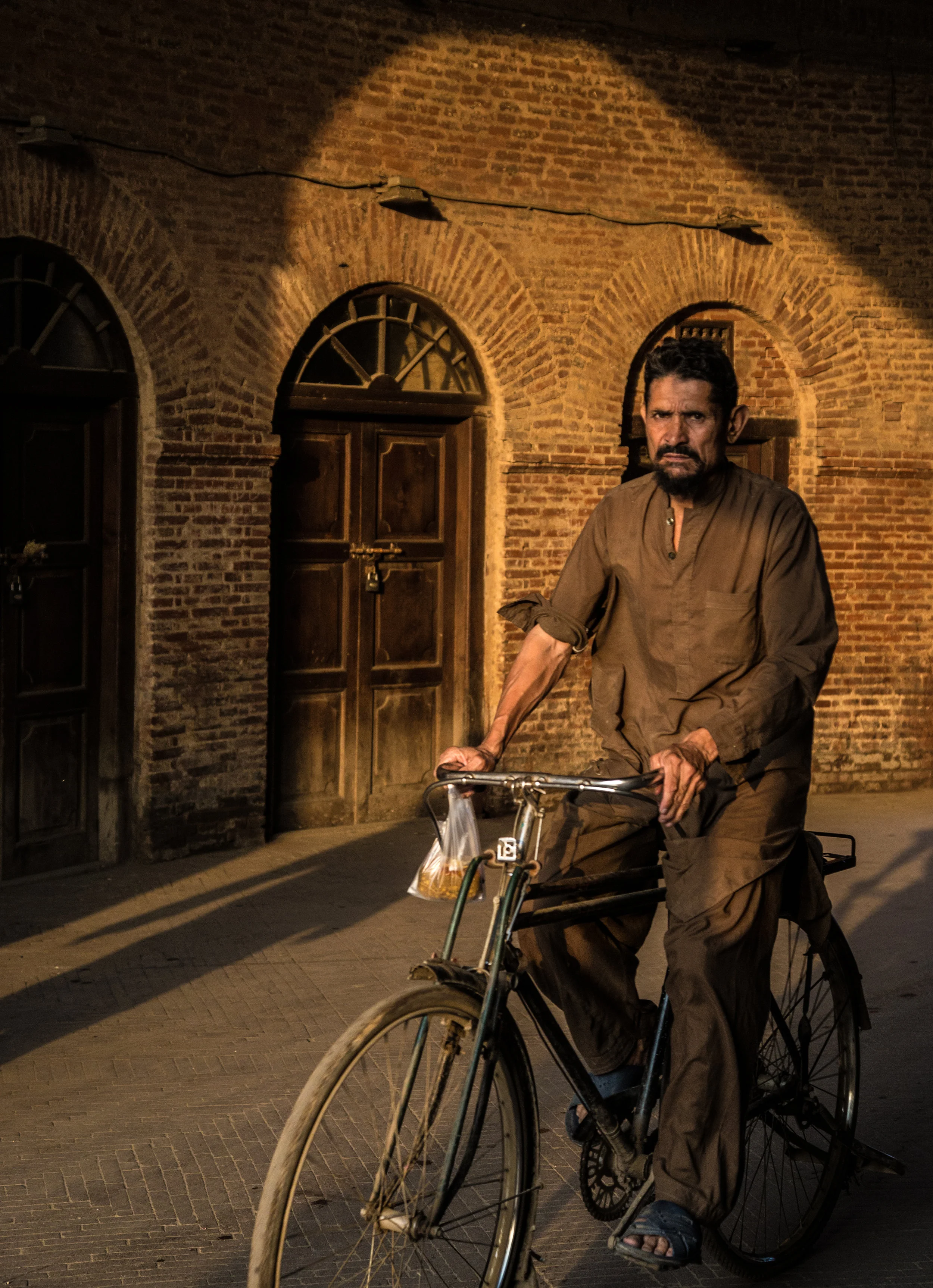 man riding a bike, photos of pakistan, street photography in pakistan, photography for sale, street photography for sale, travel photography
