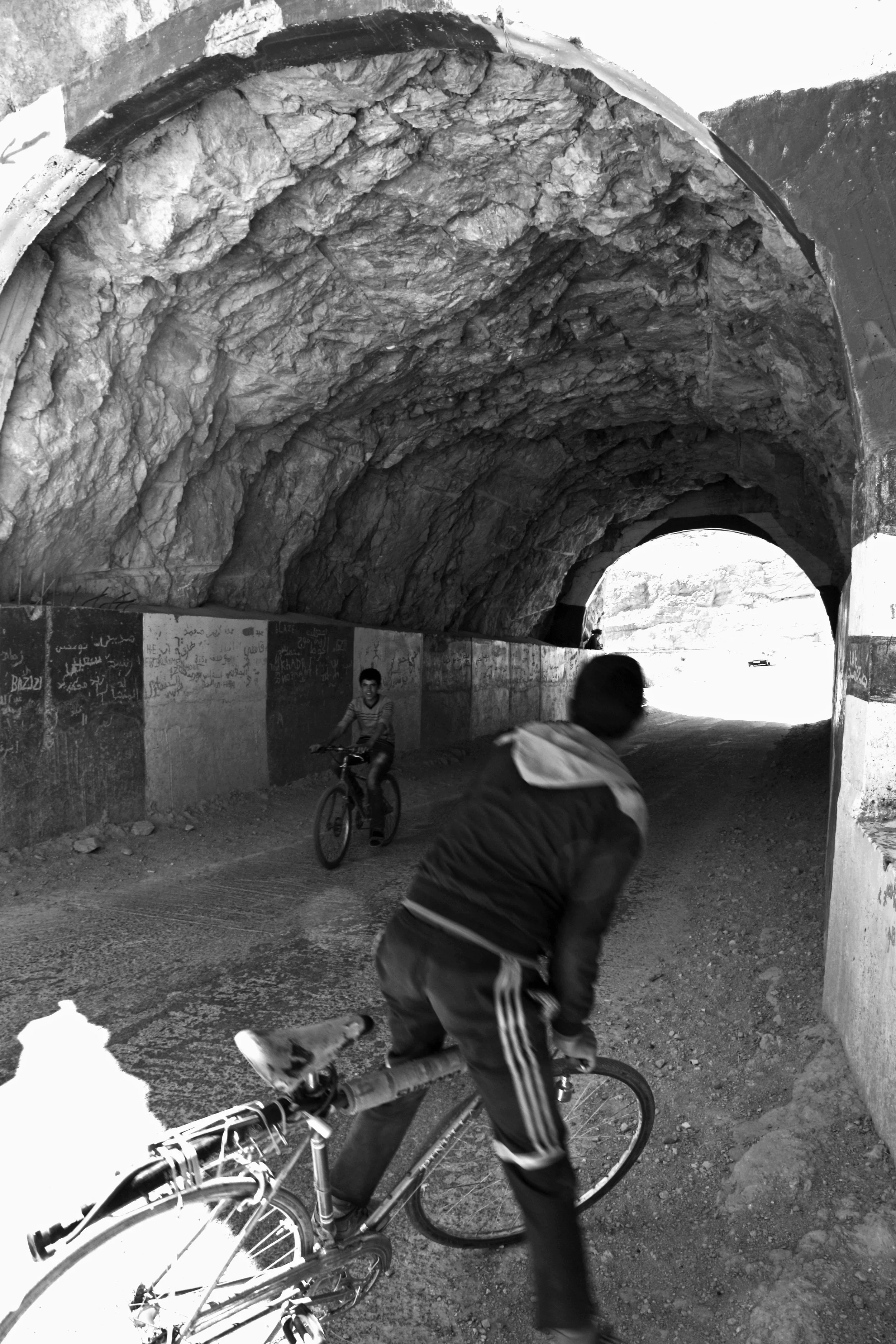 two kids on a bike in a tunnel, street photography, kids riding bikes, photograph prints to buy
