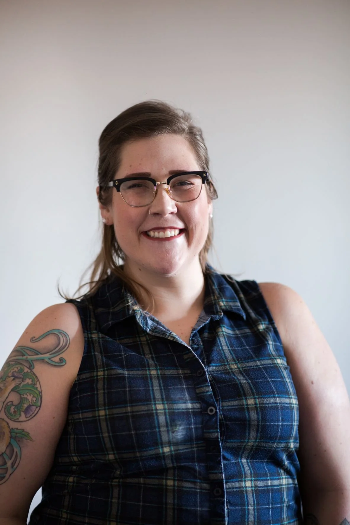 Riley Wignall wearing glasses smiling at the camera.