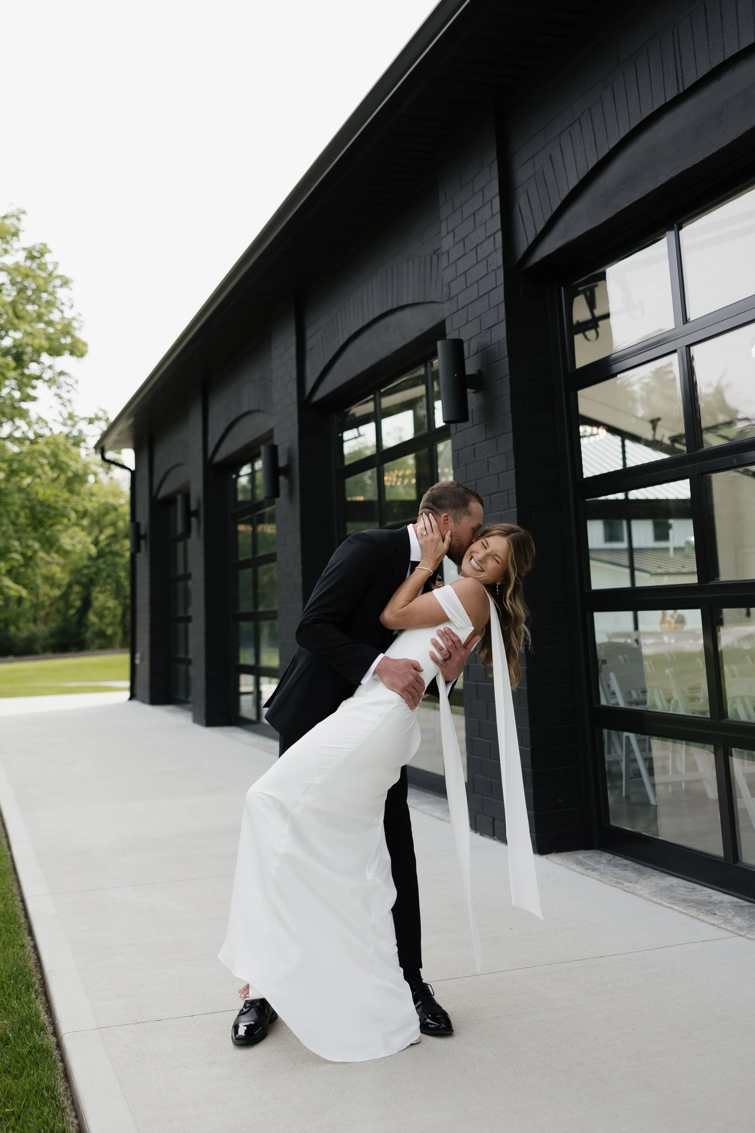 Couple outside the Glass House at Cliffside Acres wedding estate in Springfield, Ohio