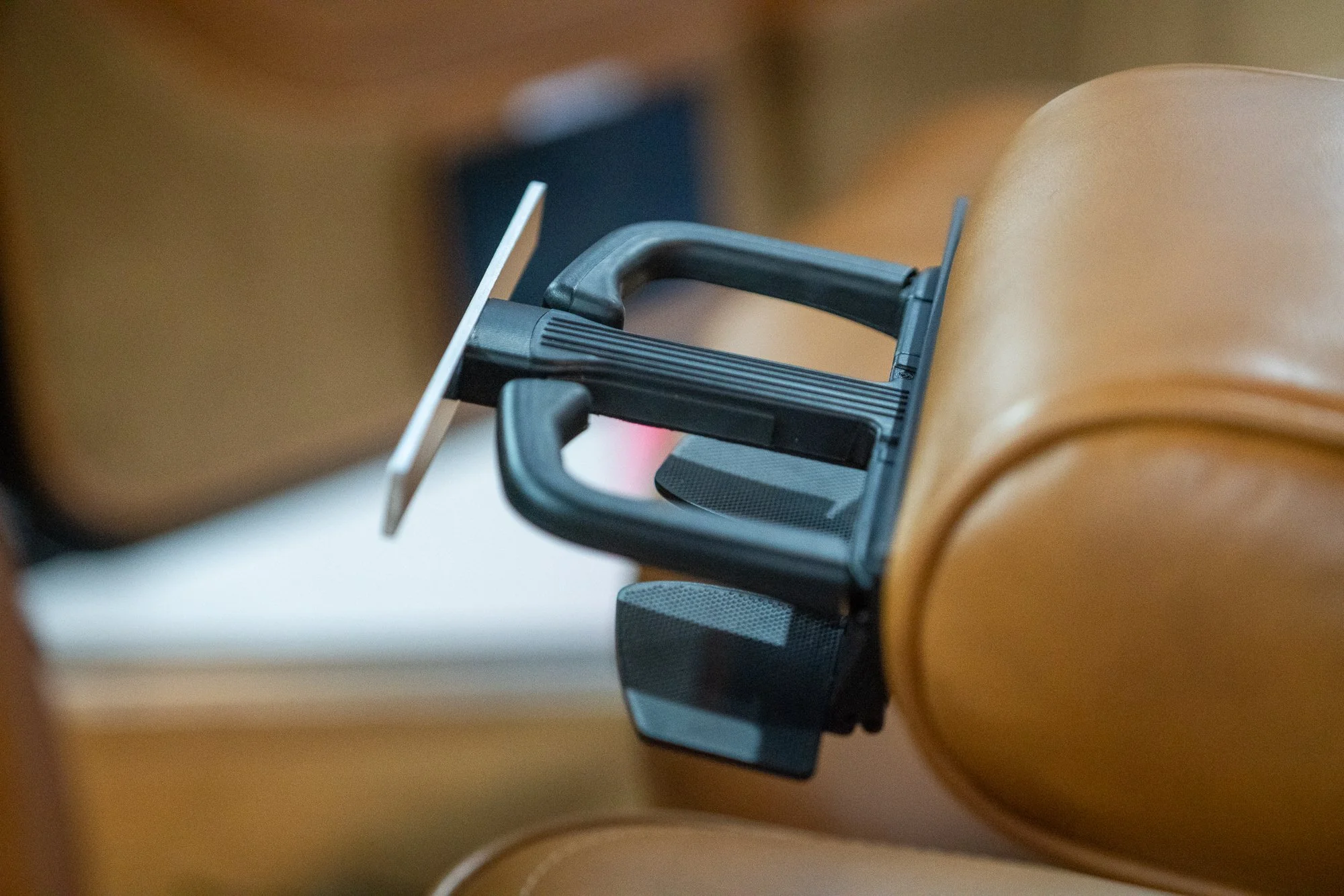 Retractable cup holder extended from Jeep Wagoneer armrest