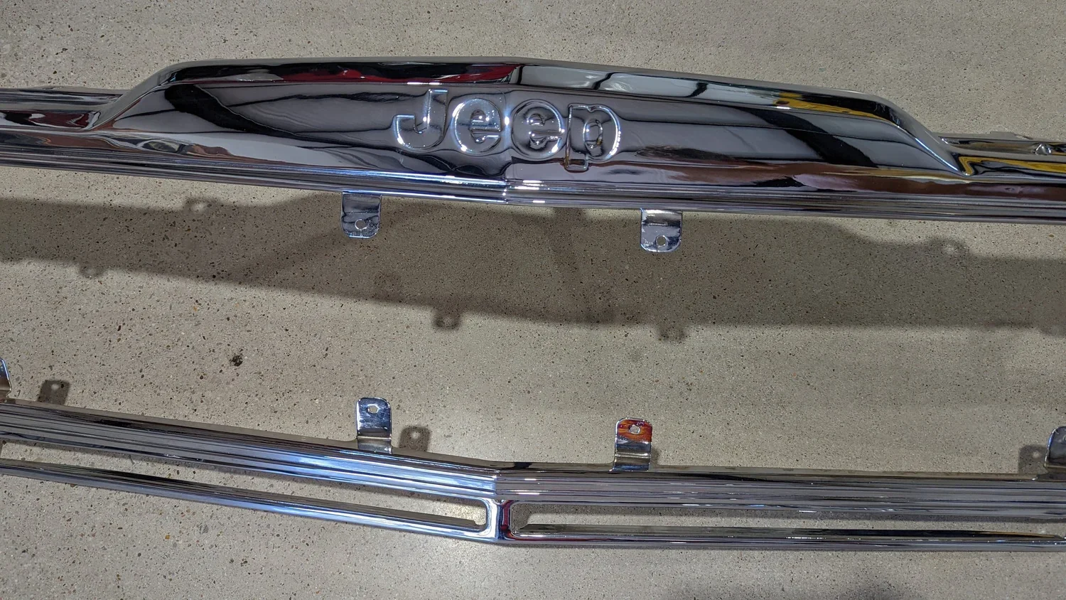 Close-up of chrome Muscle Grille corner showing detailed restoration work