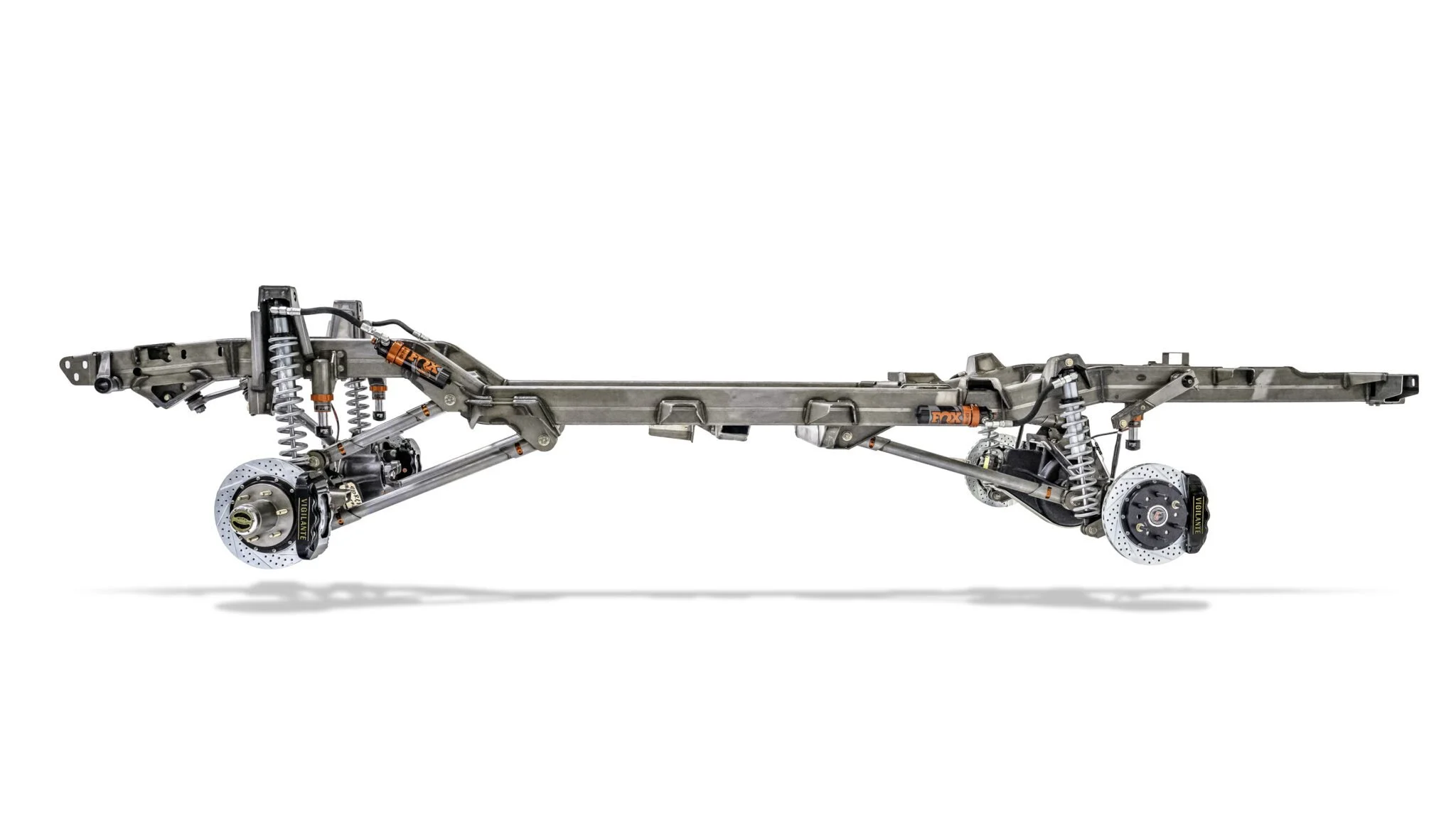 Side profile of the Vigilante Rolling Chassis engineered for Jeep Wagoneer and Cherokee models, highlighting the low stance, Fox Racing coilovers, and 4-link suspension setup.