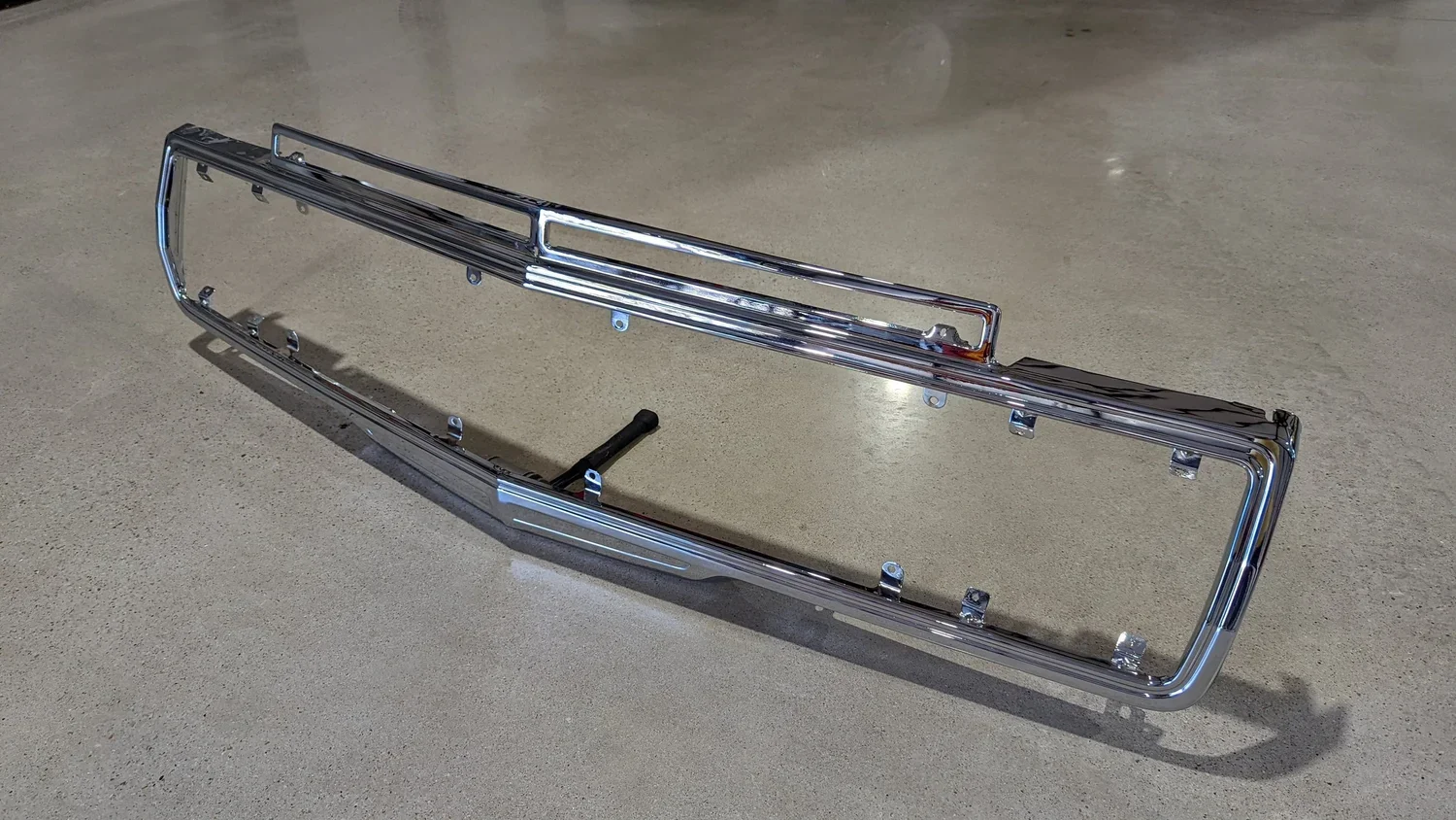 Side profile of chrome Grand Wagoneer grille surround