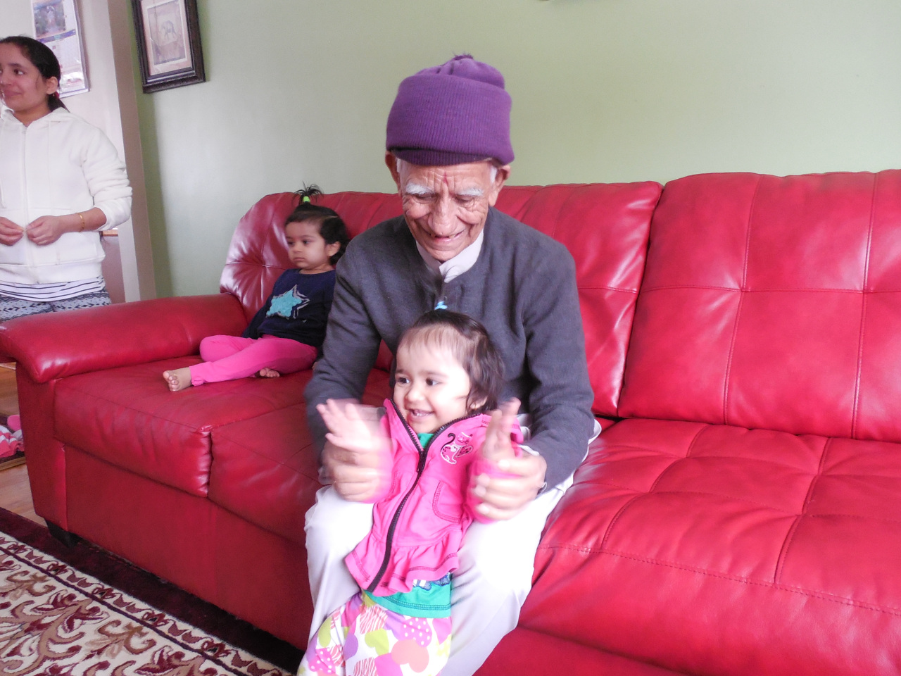 Here Ganga plays with his granddaughter in his home in Finneytown.