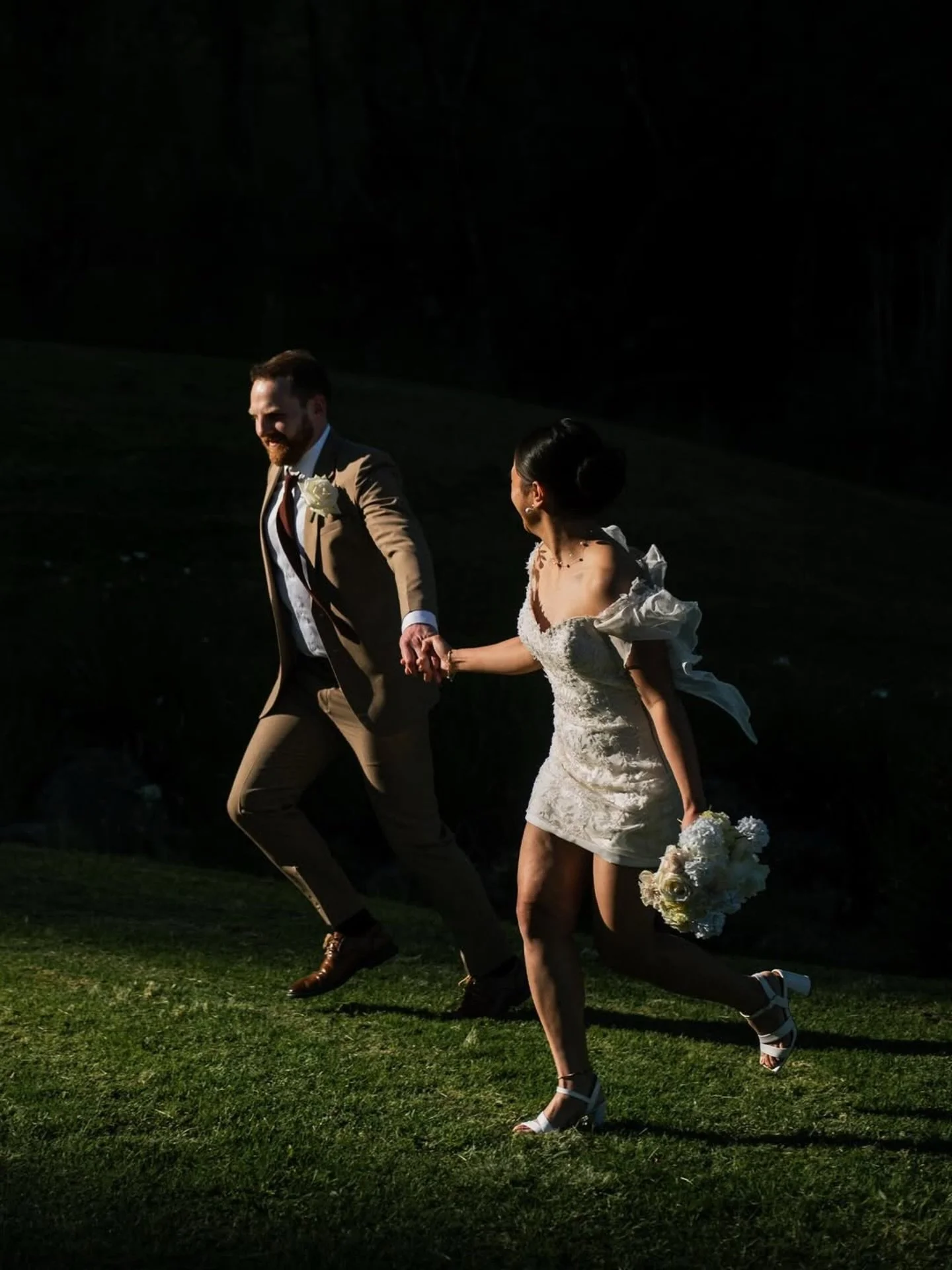 &lsquo;The sun burst through the trees at just the right moment, casting a stunning spotlight on these joyful newlyweds. It looked absolutely magical! ☀️
📸 @johndonaldsonphotography 
#nzbrideandgroom #nzwedding