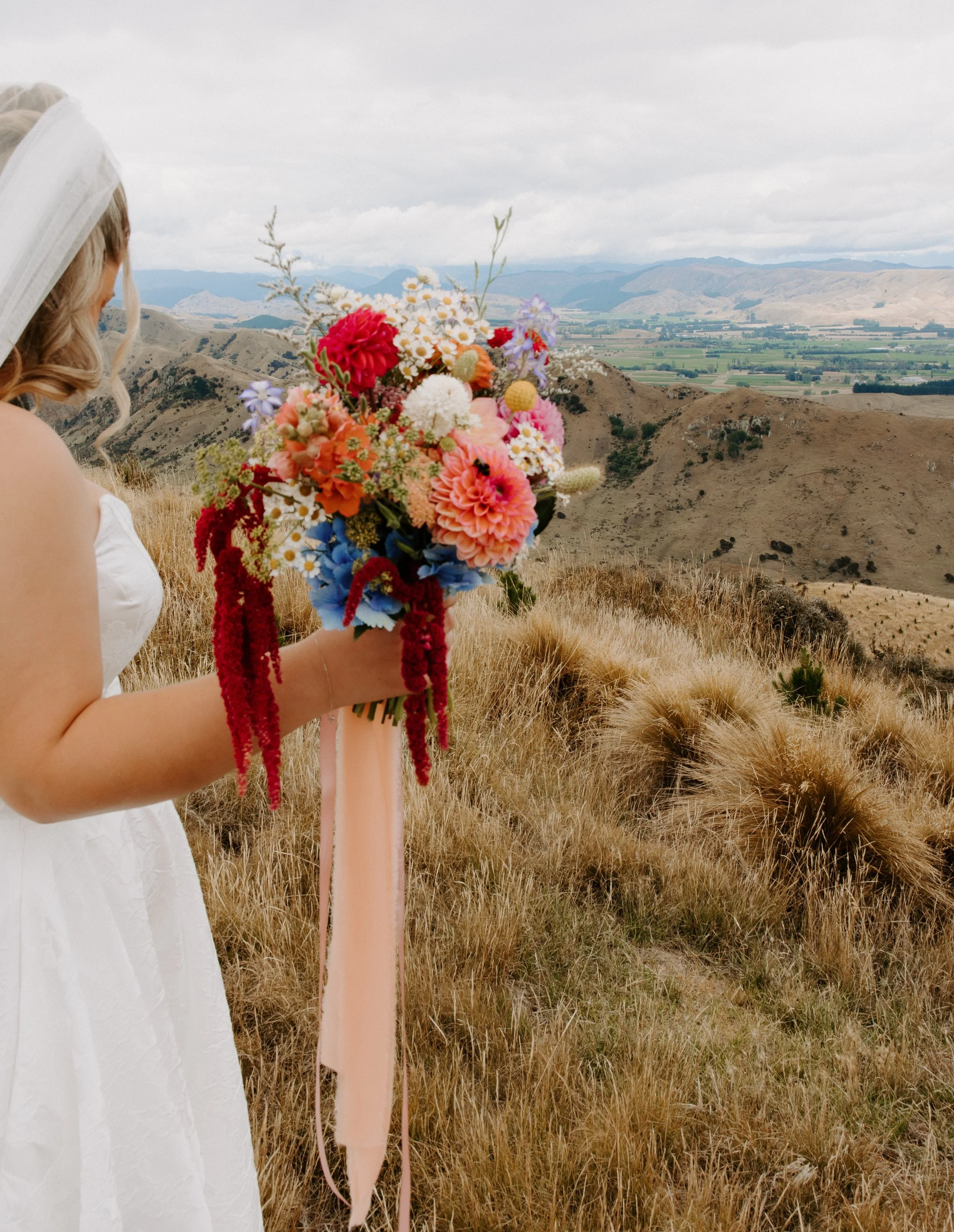 FLOWER LOVE 🌸 NEW WEDDING FEATURE // &ldquo;Since we were taking our photos at the family farm in the middle of summer, we wanted to add a bright element to the dry, brown landscape. I knew we needed colourful, stunning flowers to make the photos st