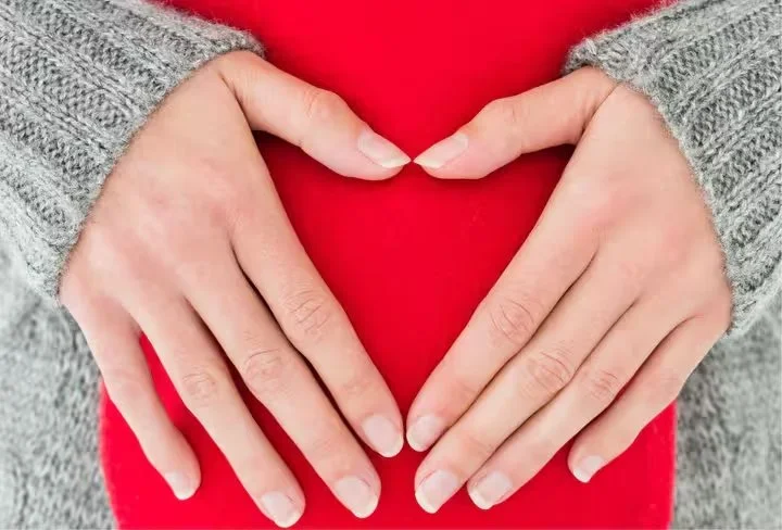 Tazi-mid-section-woman-holding-red-hot-water-bag-abdomen_converted.jpg