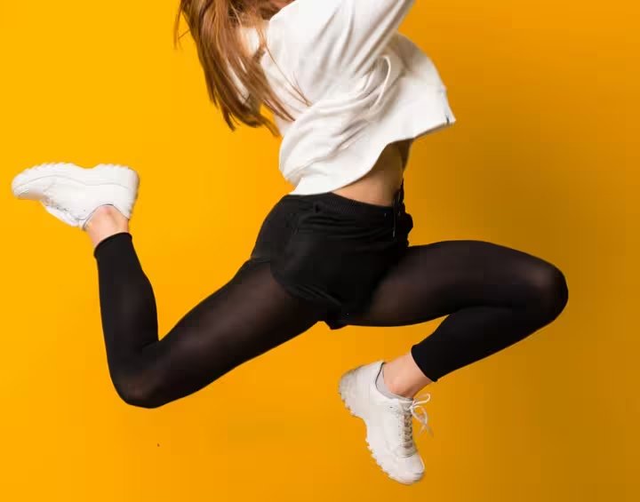 Tazi-young-woman-jumping-isolated-yellow-wall_converted.jpg