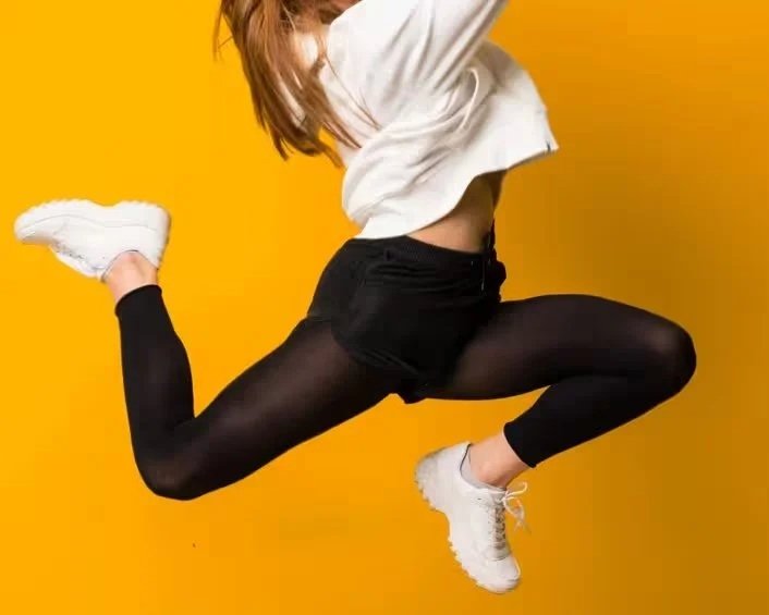 Tazi-young-woman-jumping-isolated-yellow-wall_converted.jpg
