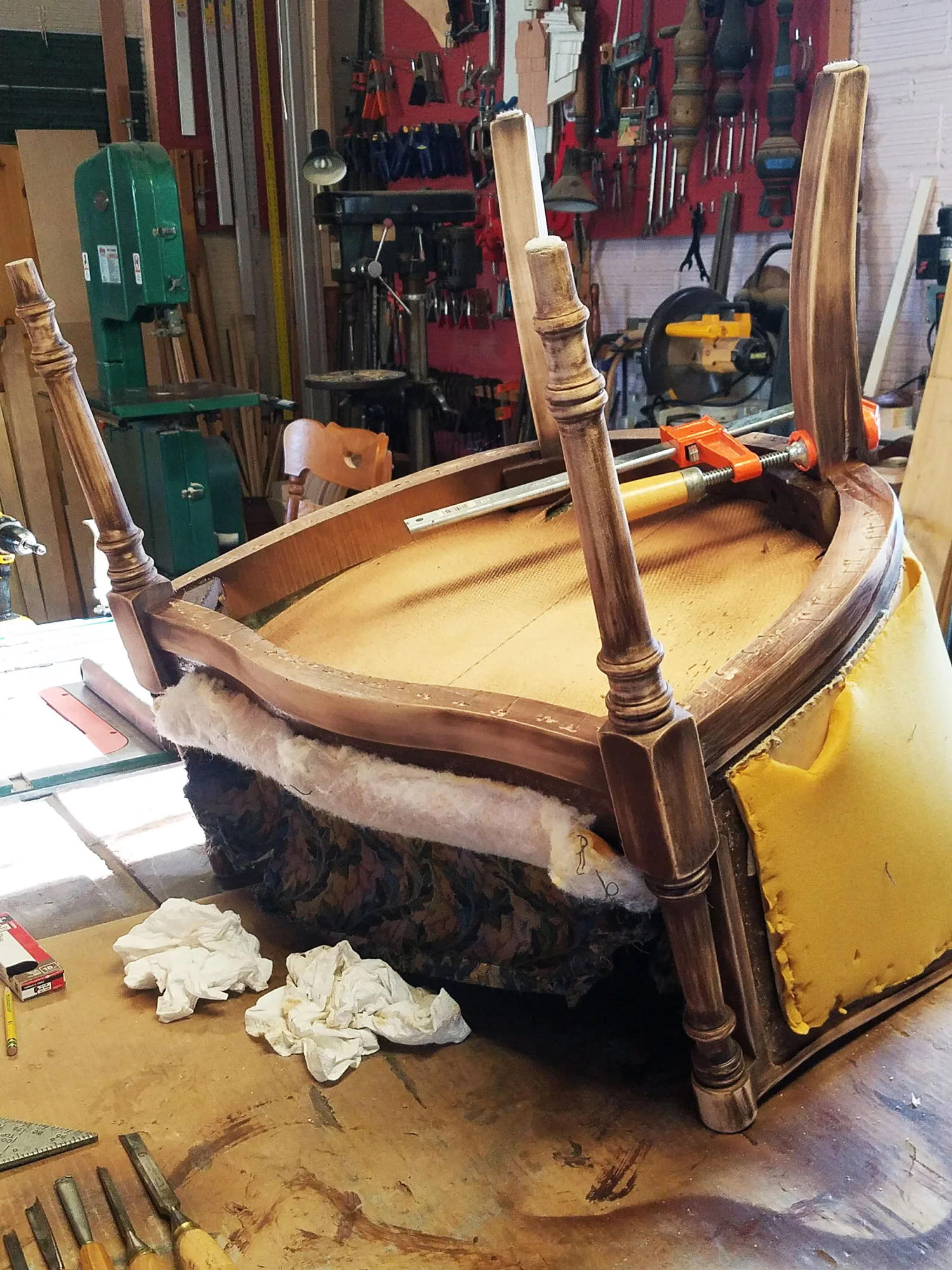 Repairs were needed on the leg of this chair for structural support, before it was refinished and reupholstered.