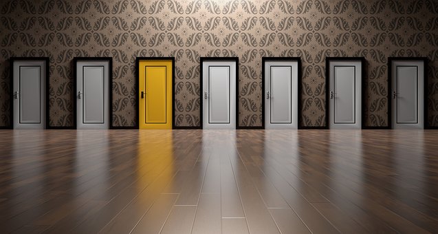 a row of grey doors with a yellow one near the middle - how to choose your Fibromyalgia ME CFS Practitioner