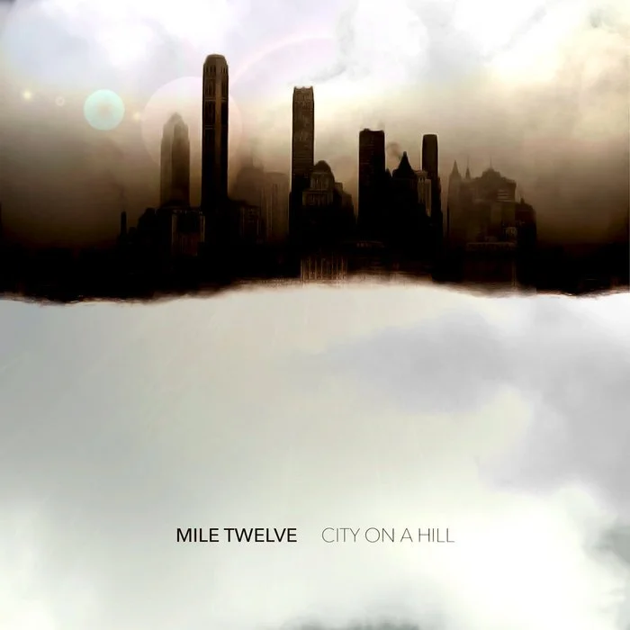 Futuristic city skyline with tall skyscrapers, reflected upside-down in a mirror-like surface, with cloudy sky background.