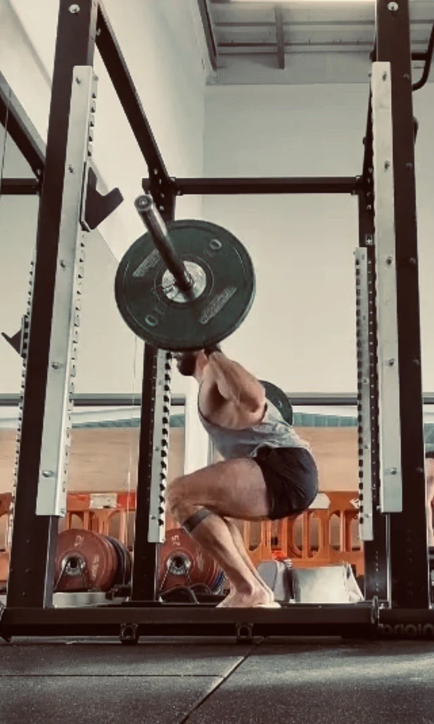 Client performing a squat during a personal training session in Brighton.