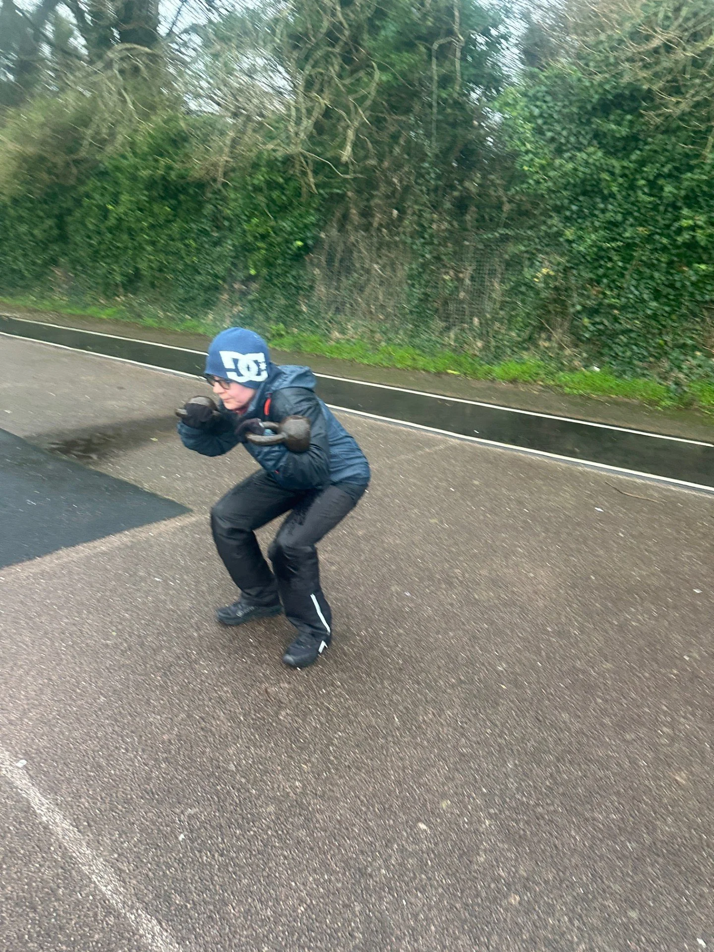 client at samuel pont training squats with kettlebells In Brighton