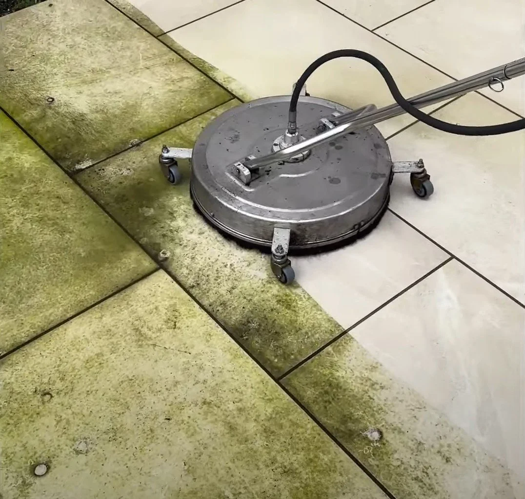 Power washing paving slabs showing the contrast between algae-stained and freshly cleaned surfaces.