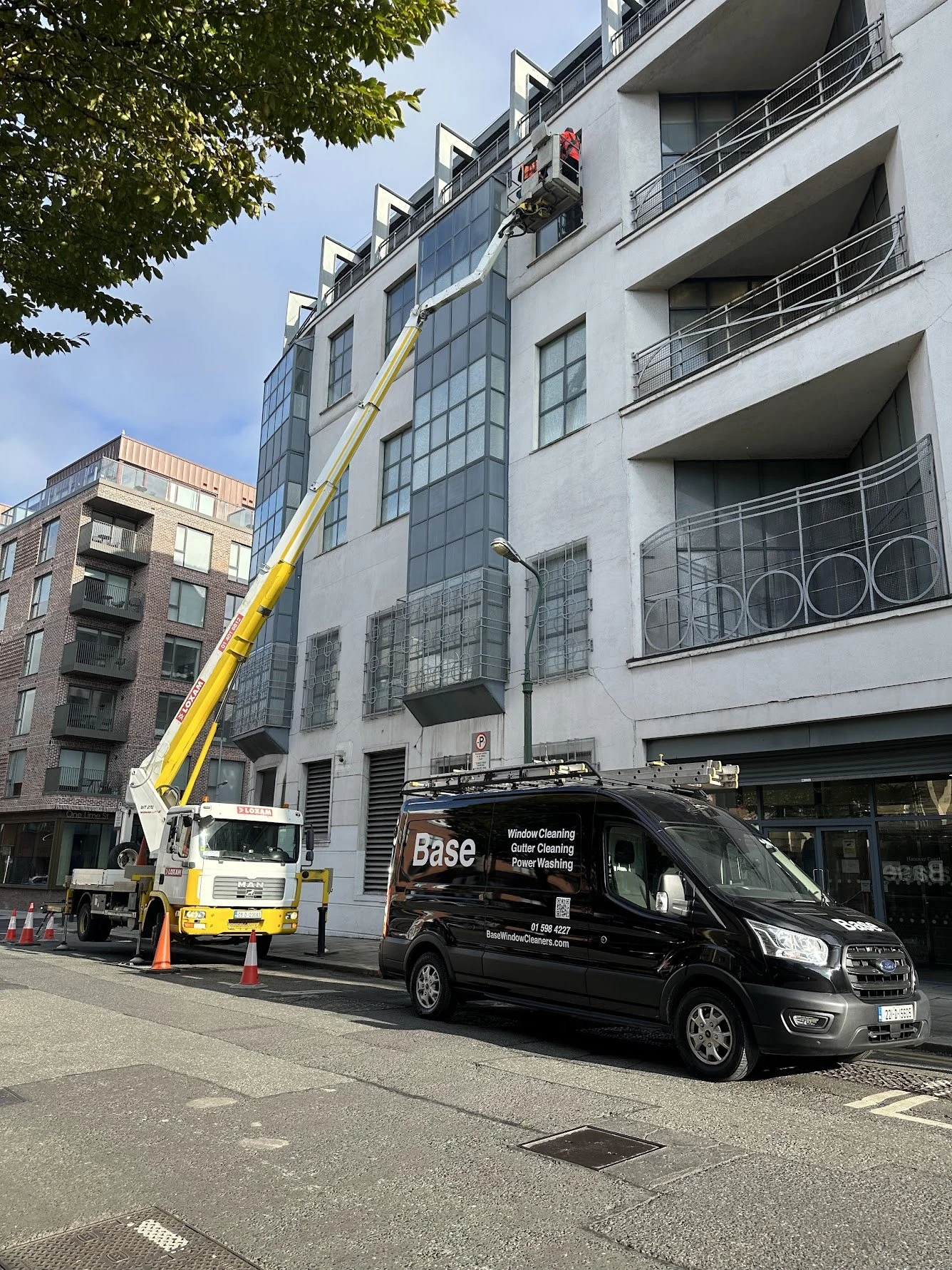 Base carrying out high-level commercial window cleaning in Dublin using specialist access equipment.