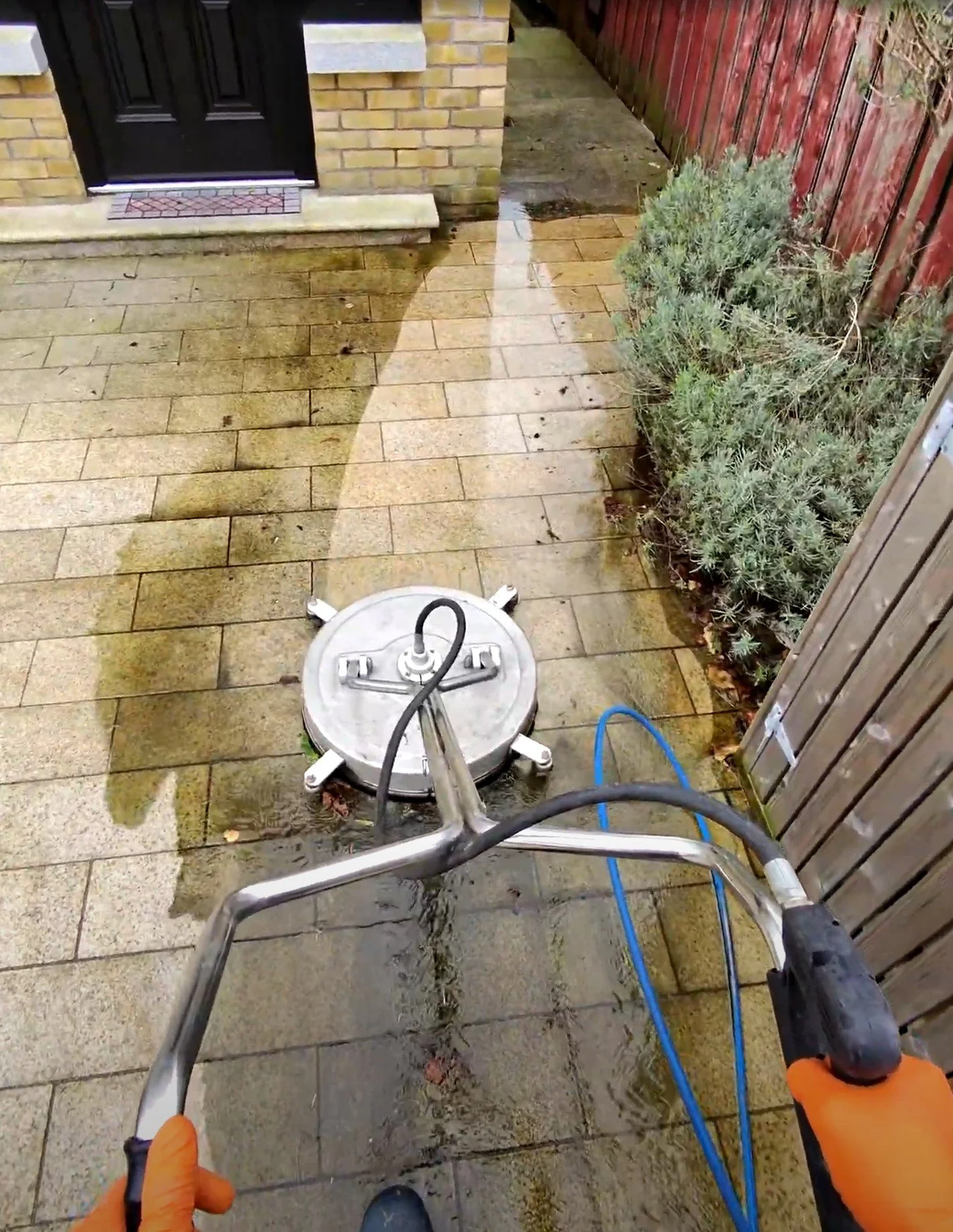 Professional surface-cleaning equipment being used to power wash paving at a Dublin property.