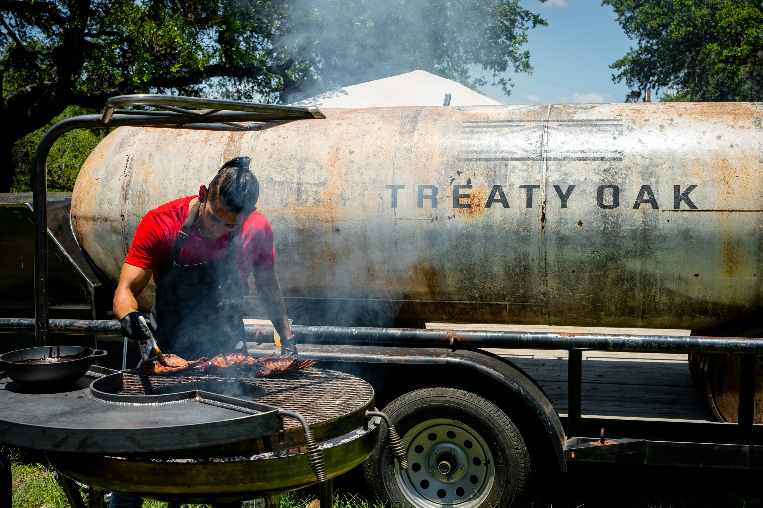 Man grilling meat on barbecue for Alice's Restaurant 