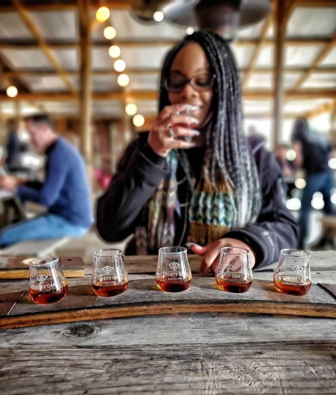 Woman drinking whiskey flight