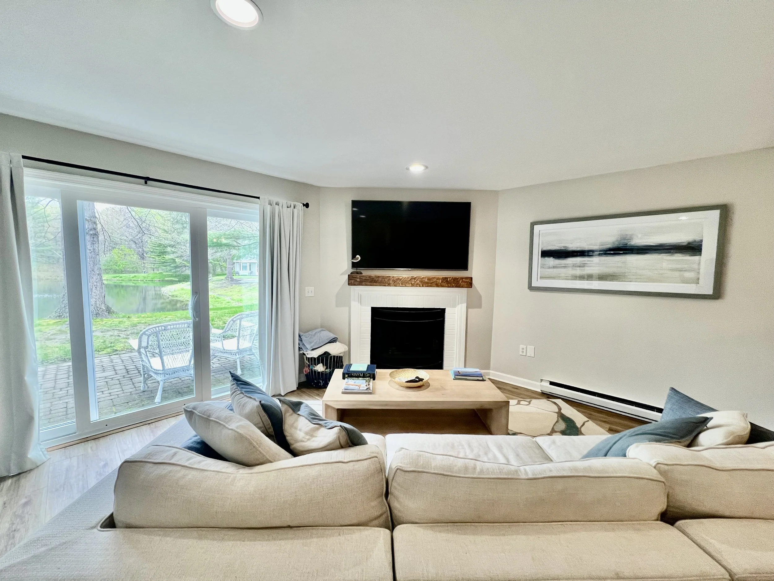 01-Living-Room-Fireplace-Pond-View.jpeg