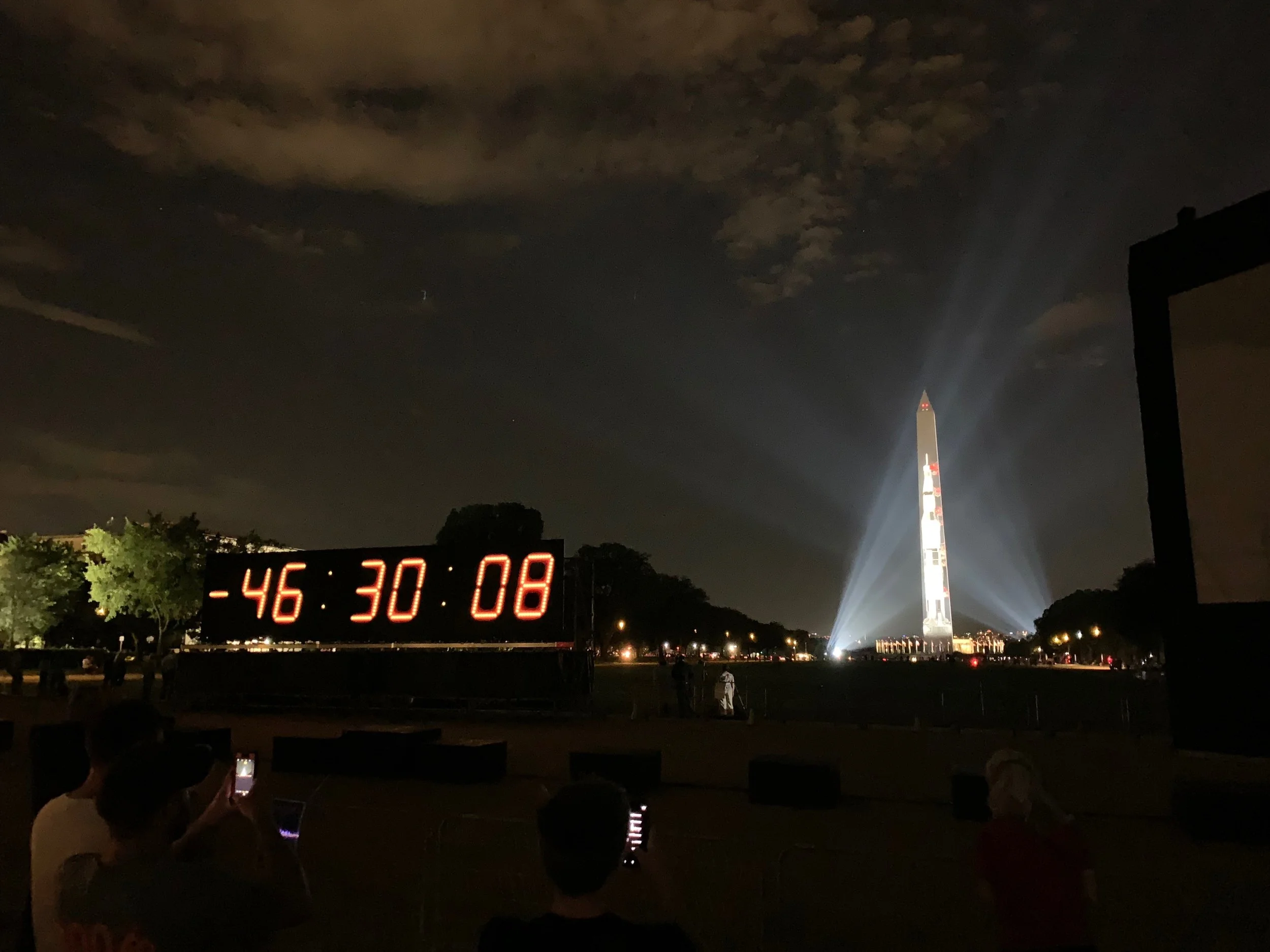 The night before, on the National Mall. The image of the Saturn V rocket with Apollo 11 crew is projected on the Washington Monument.