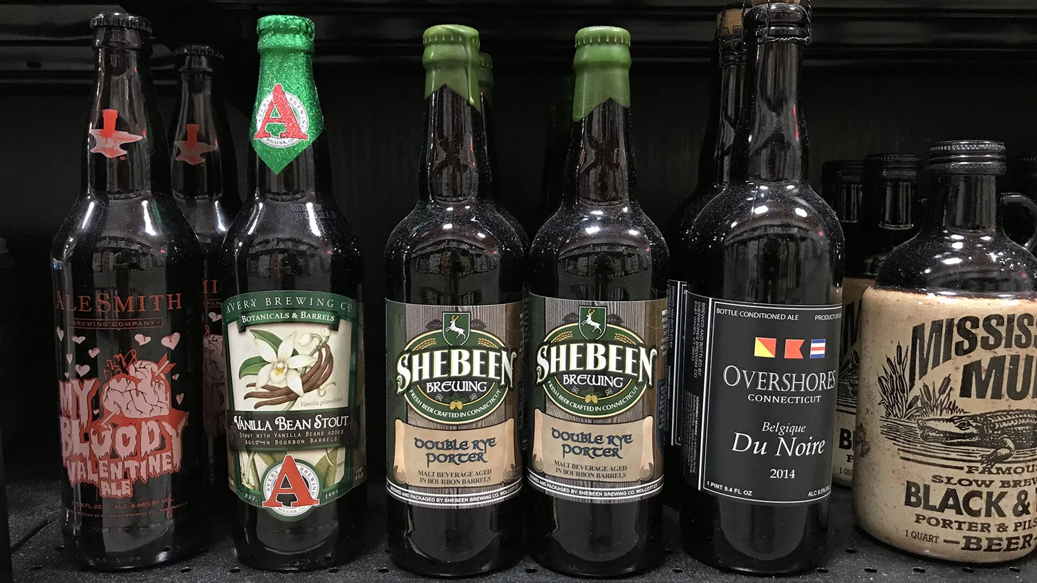 Store shelf with two Shebeen Double Rye Porter bombers between bottles from other breweries