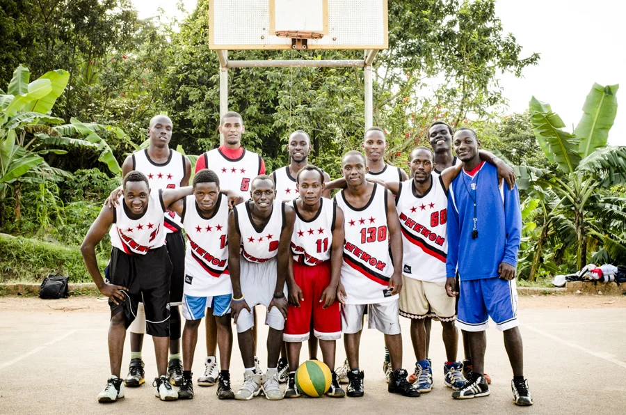 Team Phenom poses for a picture on their home court. This team was launched by the dream of two high school student athletes who wanted to combine their love of the game with their desire to help disadvantaged communities. Team Phenom strives to cre…