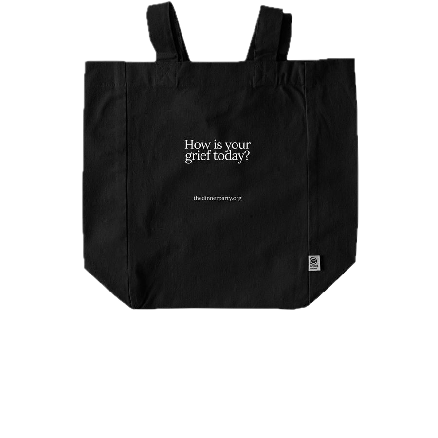 Black tote bag with white text asking 'How is your grief today?' and a website link 'thedinnerparty.org'.