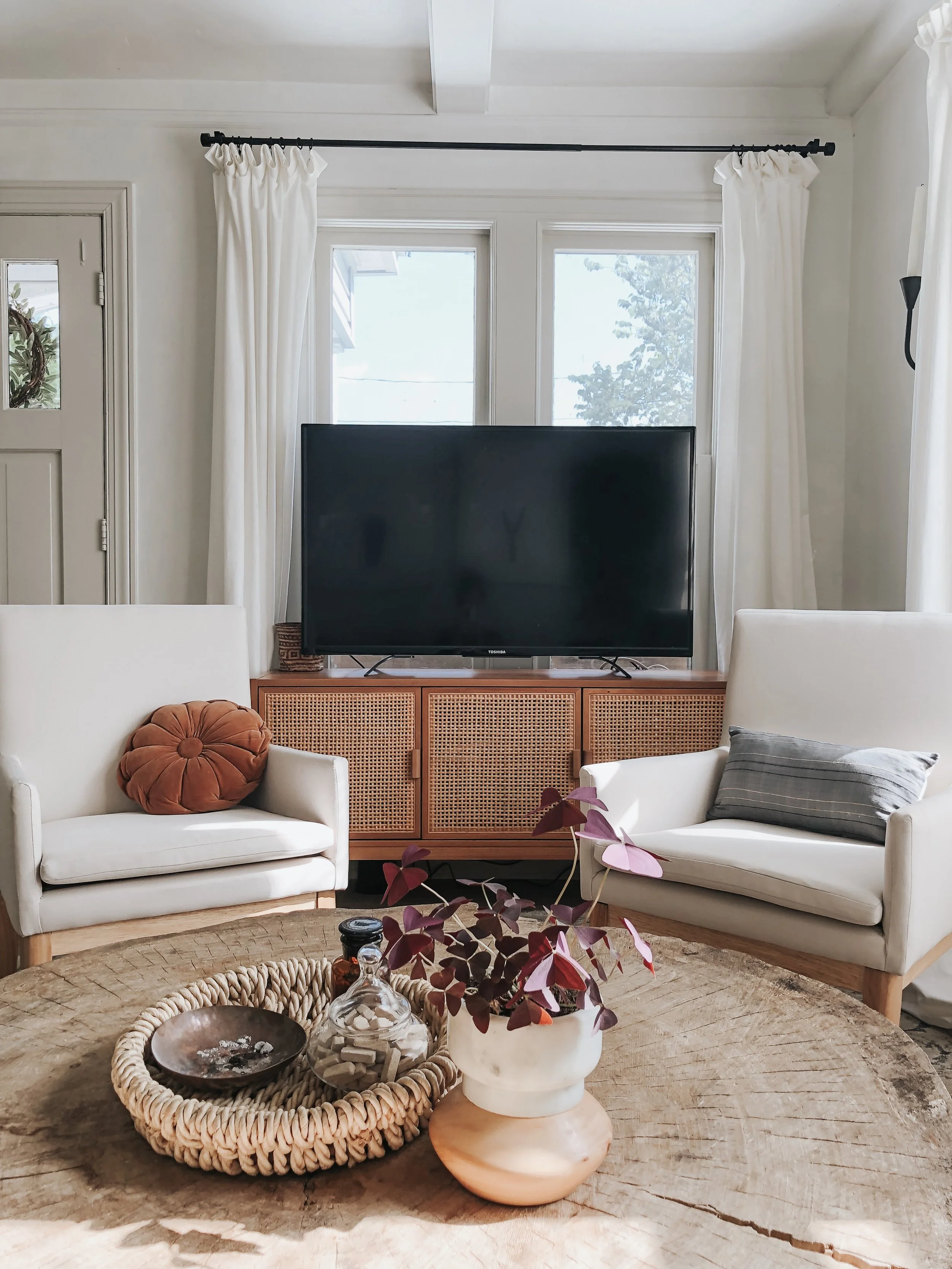 Sources: Chairs | Little knickknacks on table - all thrifted | Round rust-colored pillow - thrifted | Blue lumbar pillow | Media console table
