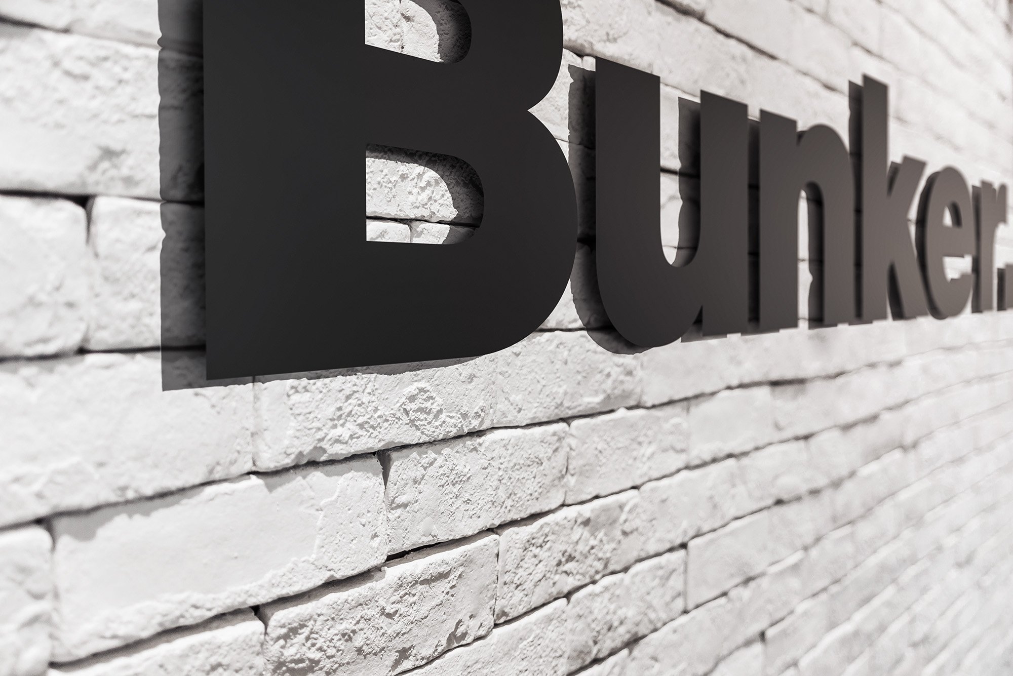  Bunker logo mounted on a white brick wall 