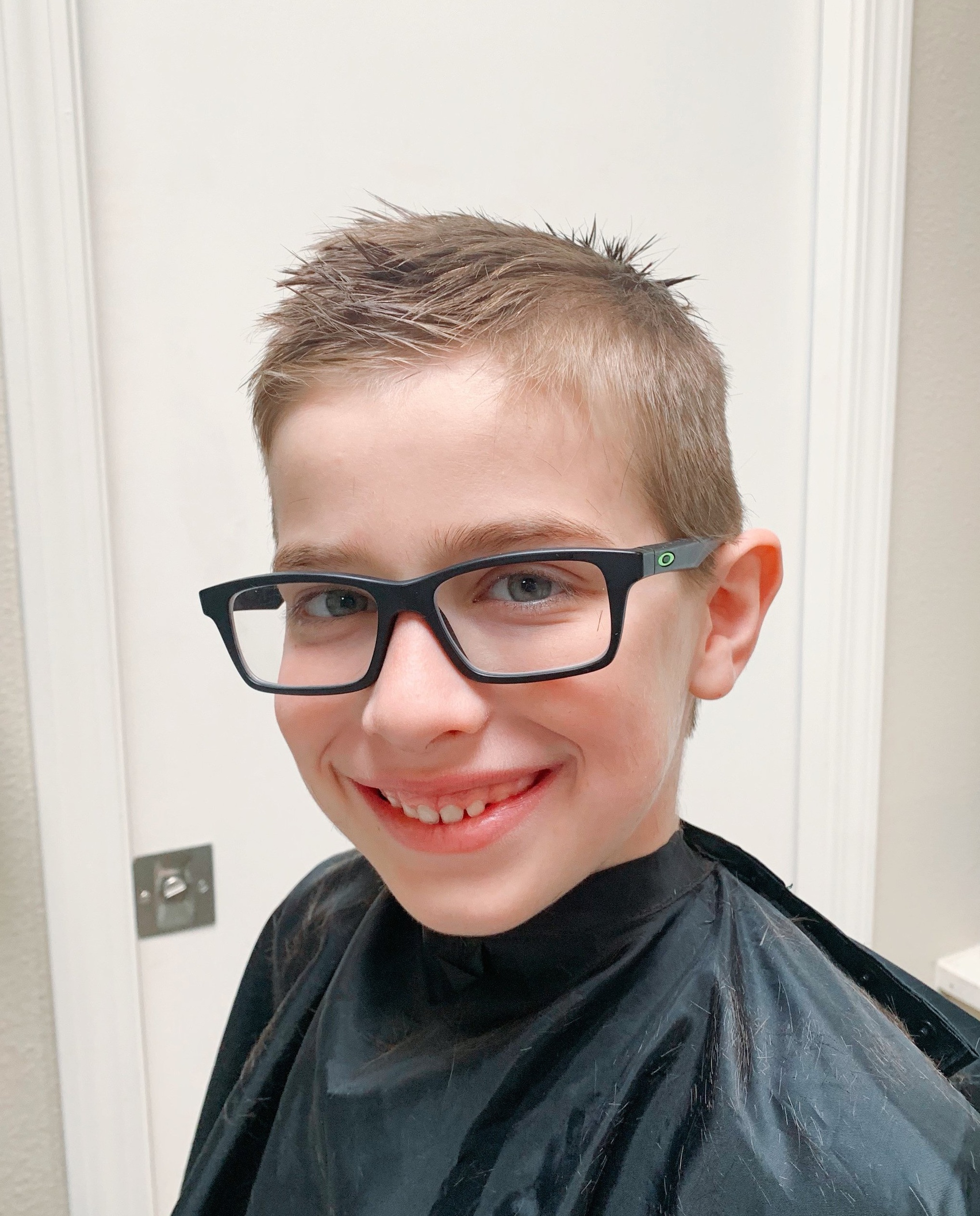 cutting a boy's hair with scissors