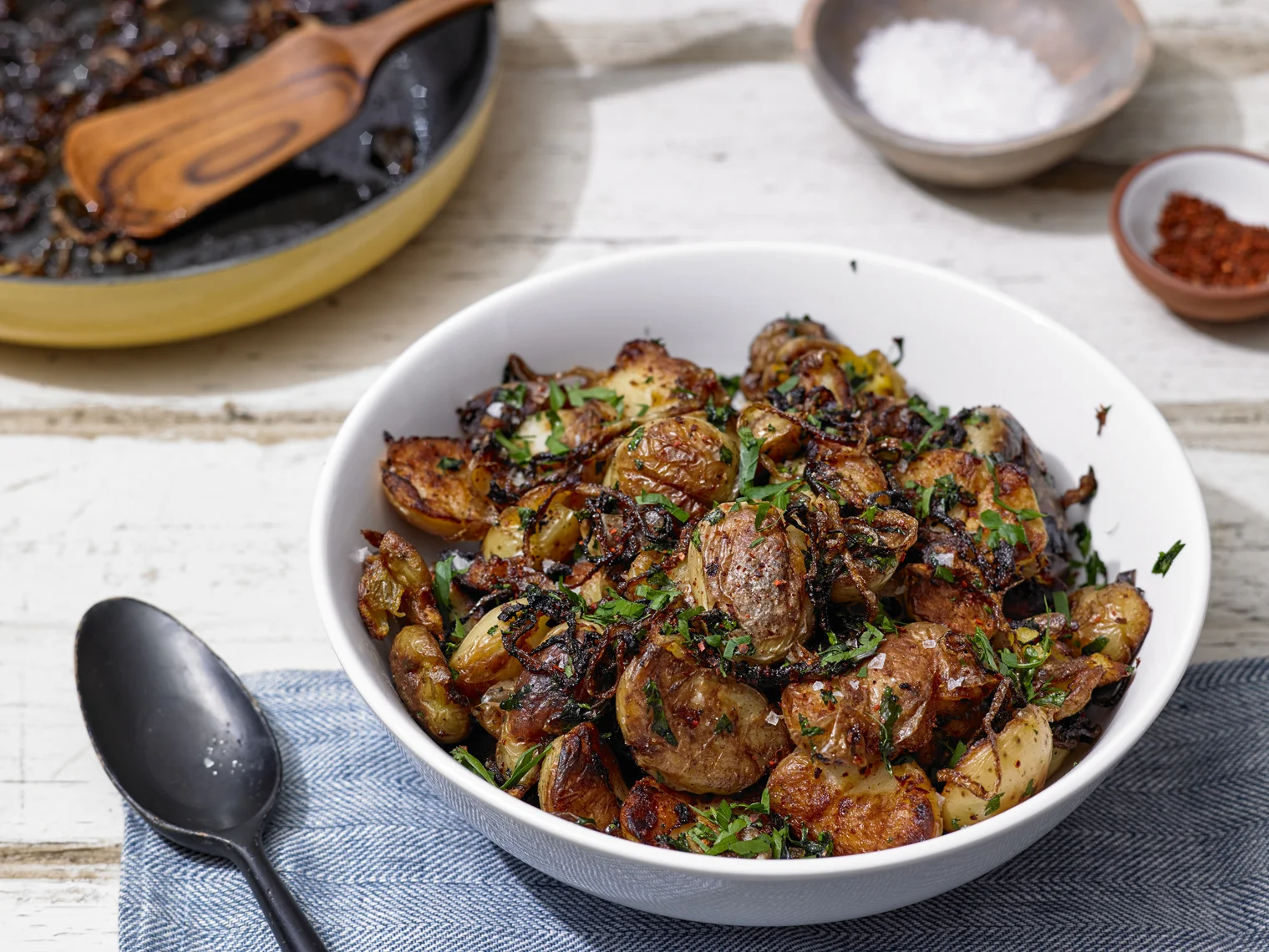 Alison Roman's Crispy Smashed Potatoes with Fried Onions and Parsley; photo by Michael Kraus for The New York Times