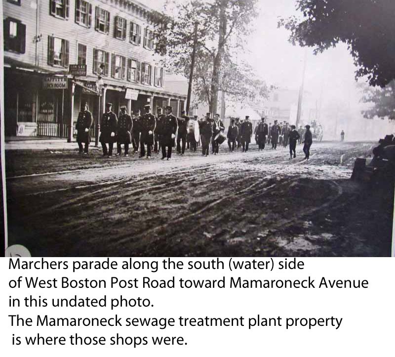  Marchers parade along the south (water) side of West Boston Post Road toward Mamaroneck Avenue in Mamaroneck in this undated vintage photo. The Mamaroneck sewage treatment plant property is where those shops were. 