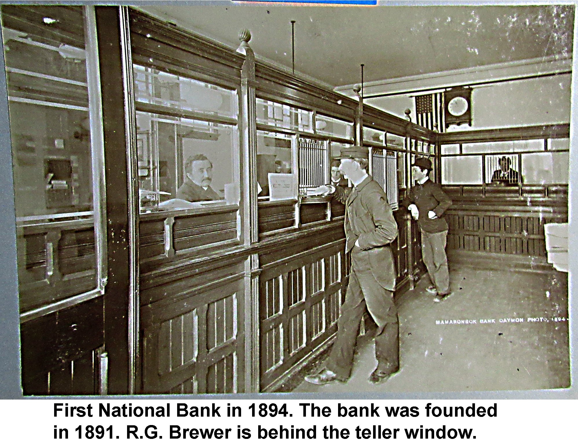 WD-02  First National Bank in 1894 founded 1891 R.G. Brewer behind teller window captioned.jpg