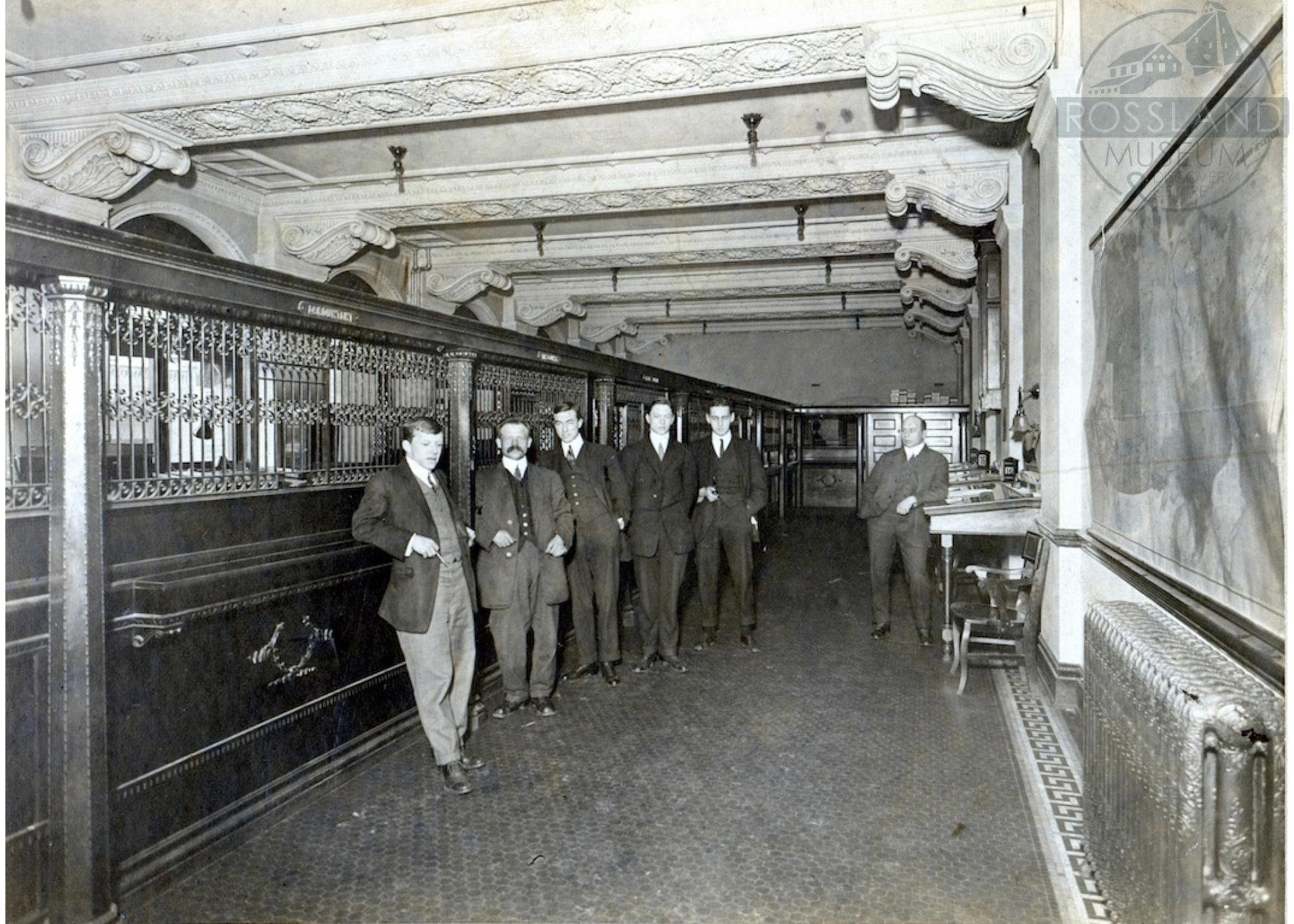   2282.0005 : A group of employees inside the Bank of Montreal in Rossland, date unknown. 